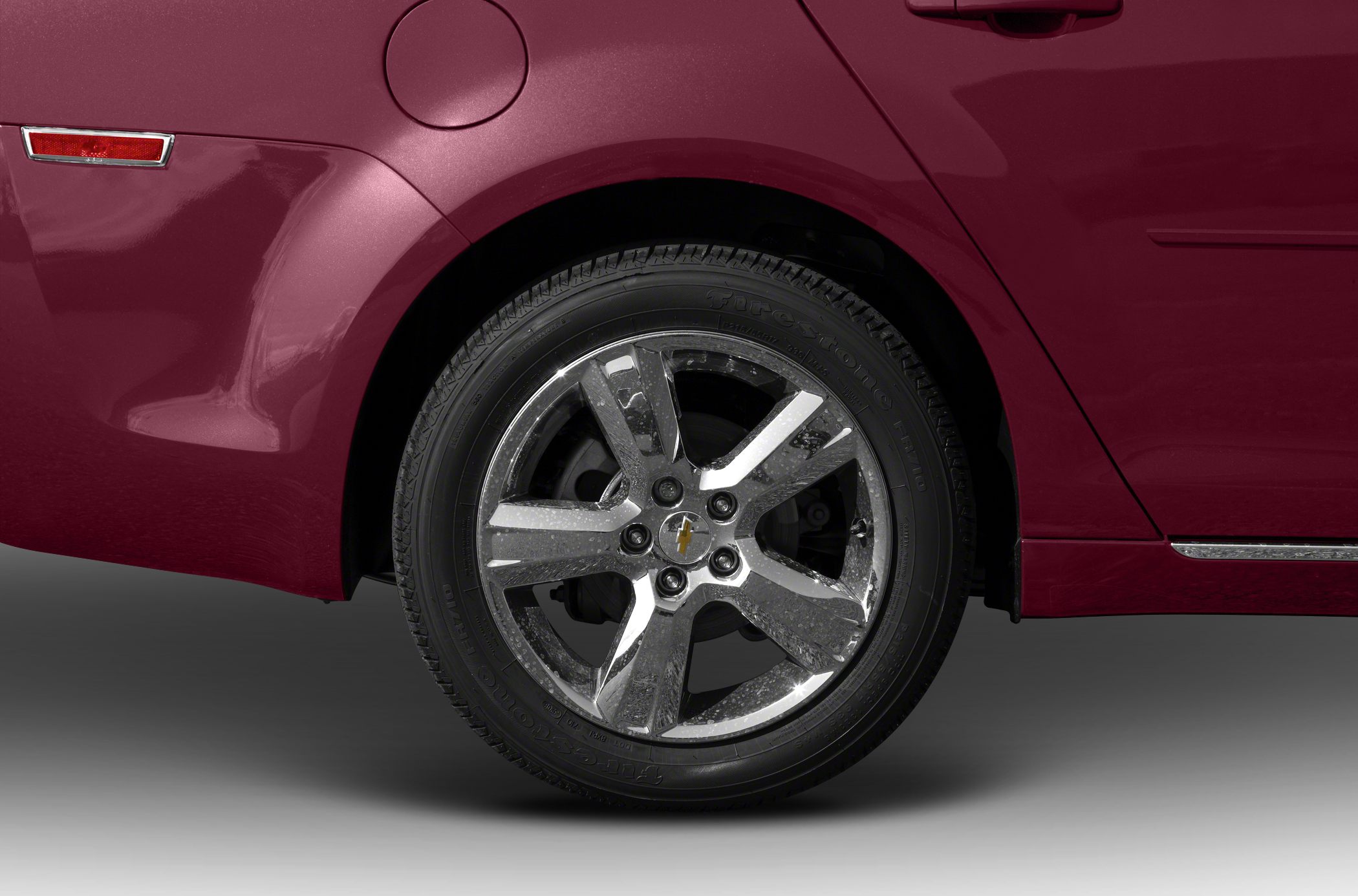 Close-up of alloy wheel and rear fender with fuel cap and side reflector