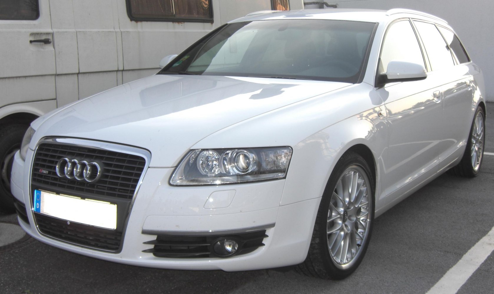 Front perspective showing grille, headlights, fog lights, and alloy wheels