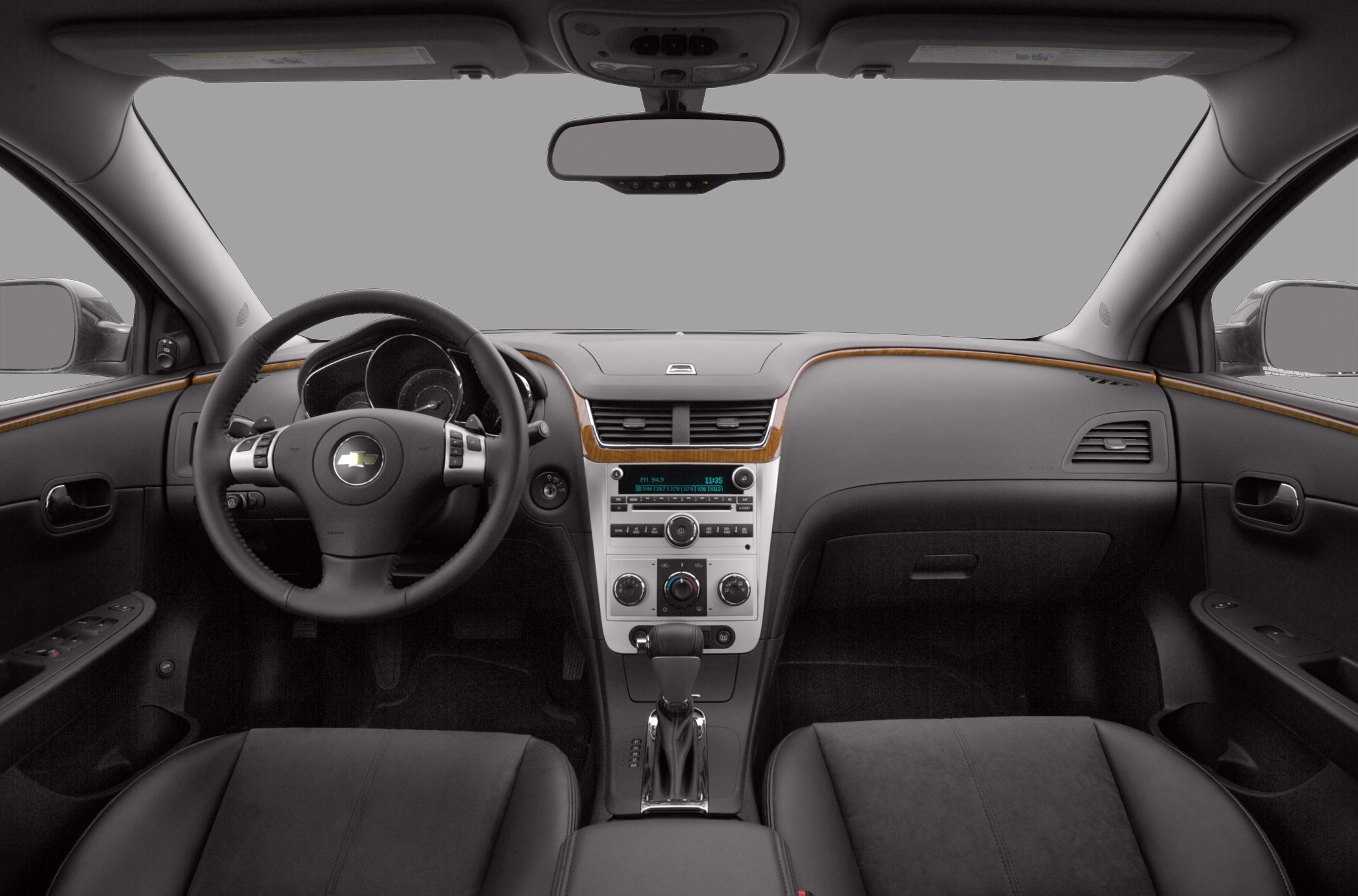 Car interior with dashboard, steering wheel, and center console.