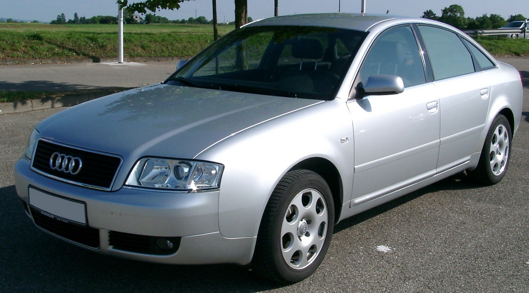 Silver sedan front side view with alloy wheels