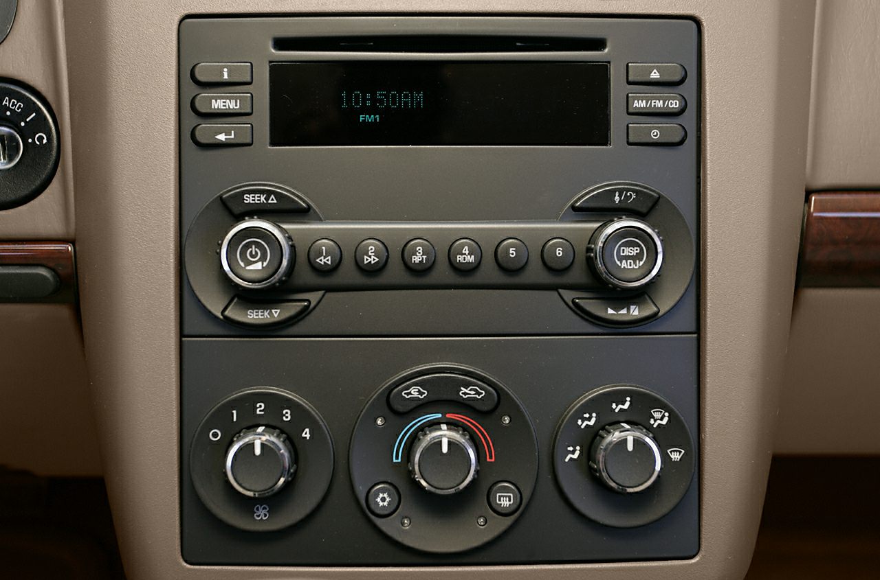 Car radio and climate control knobs on dashboard