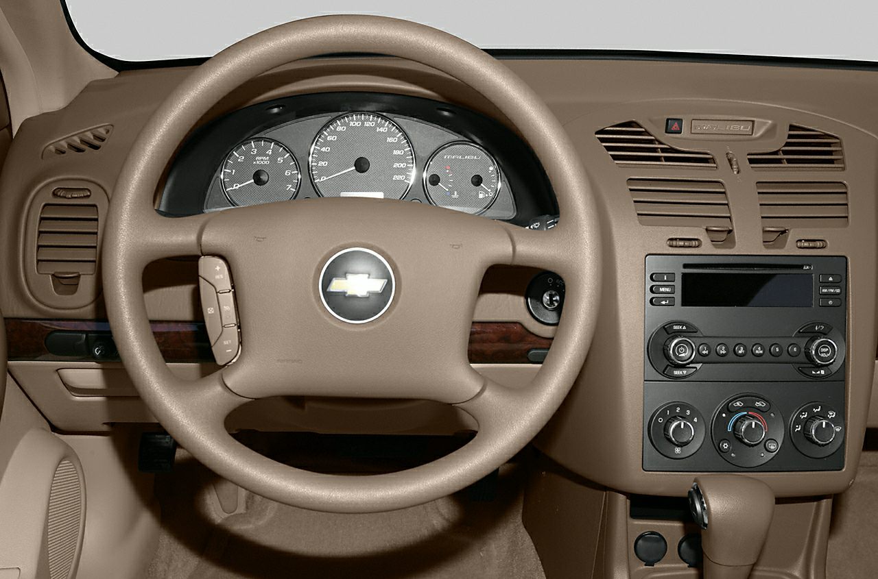 Beige steering wheel and dashboard with instrument cluster and control panel