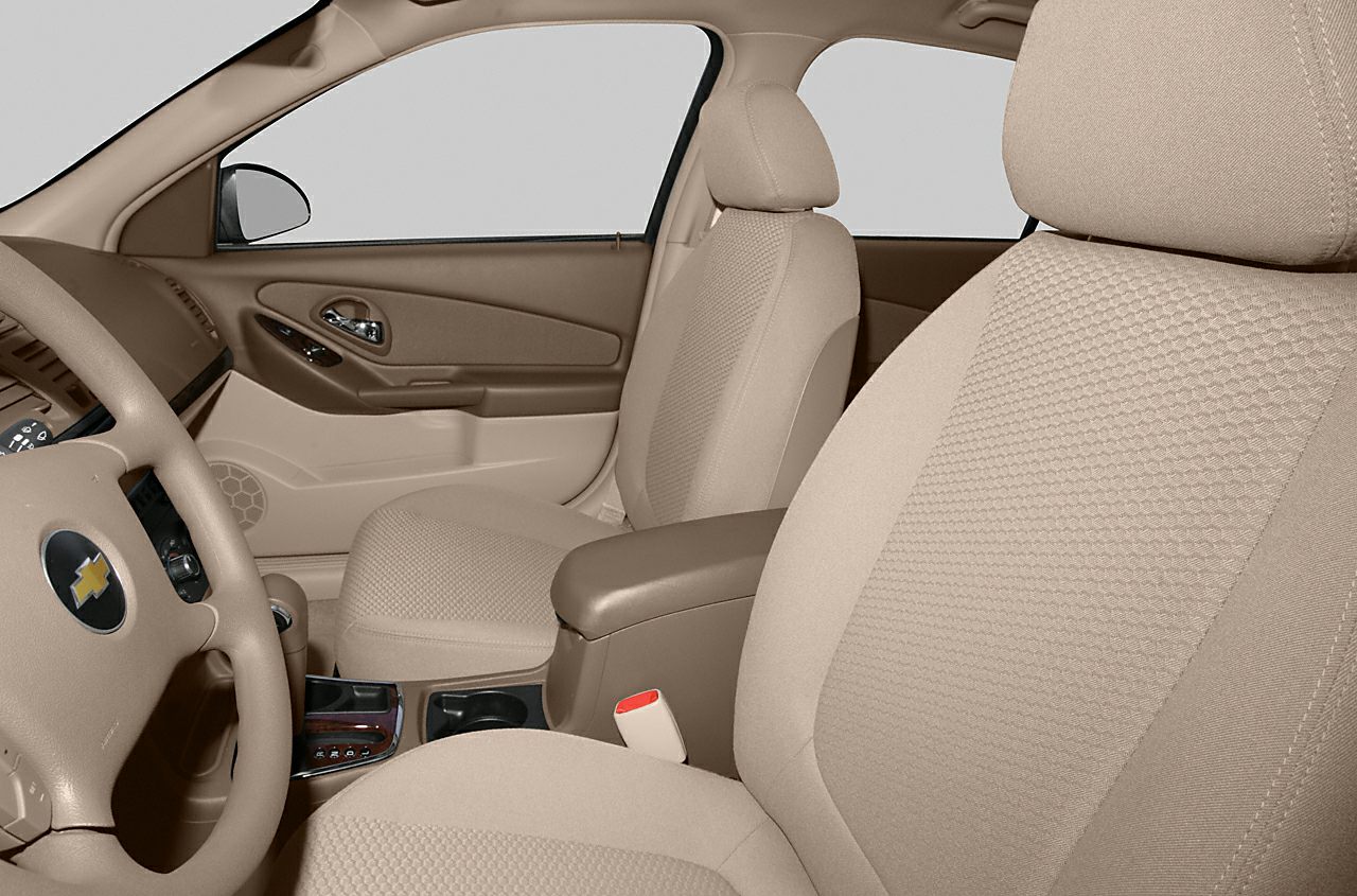 Beige fabric front seats and interior door panel with controls.