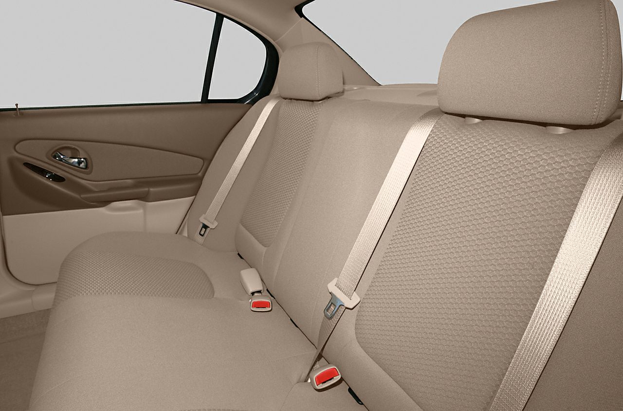 Beige rear seat upholstery with seat belts and headrests