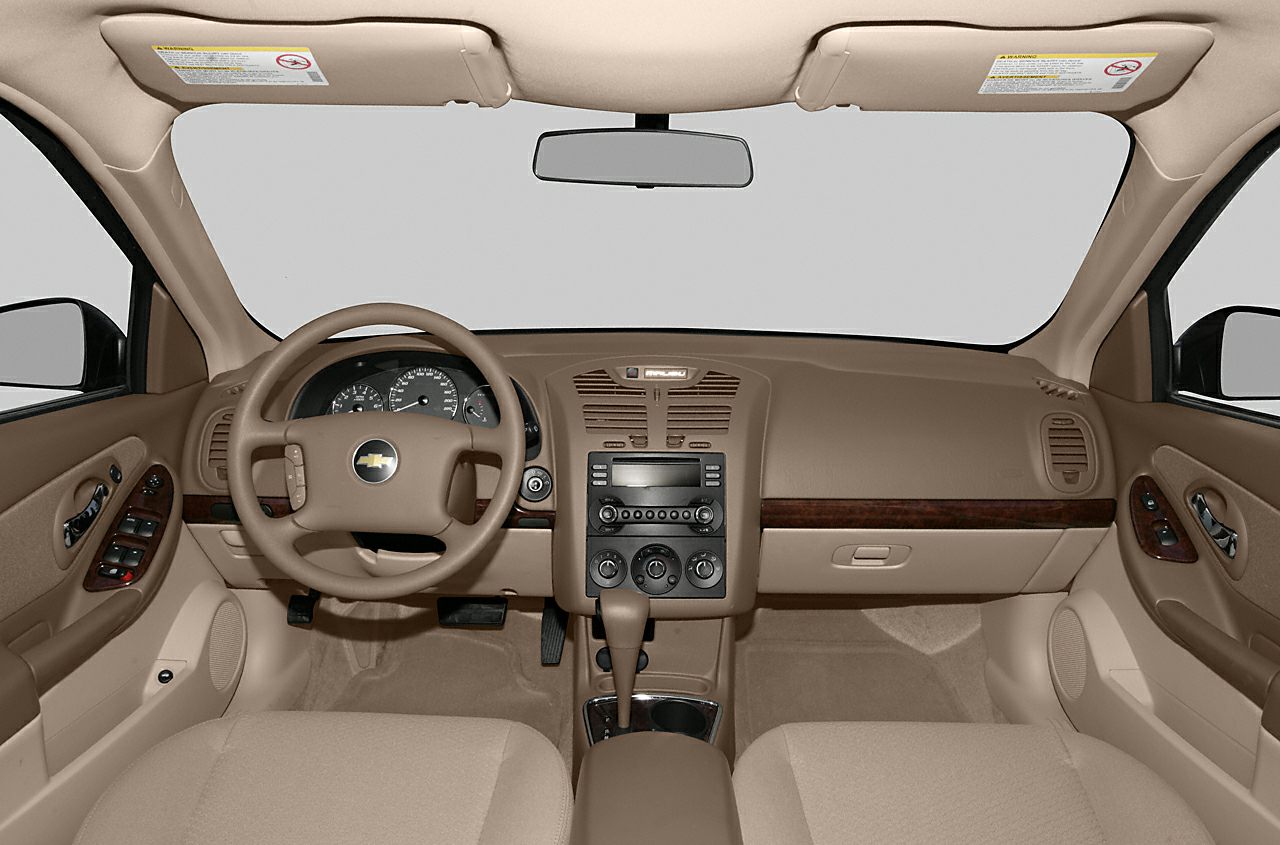 Beige dashboard and steering wheel with wood trim and central control panel