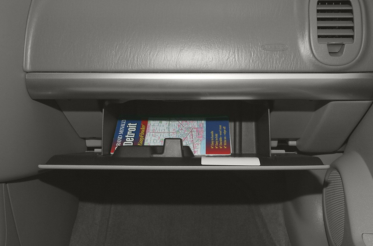 Car glove compartment with travel guide inside