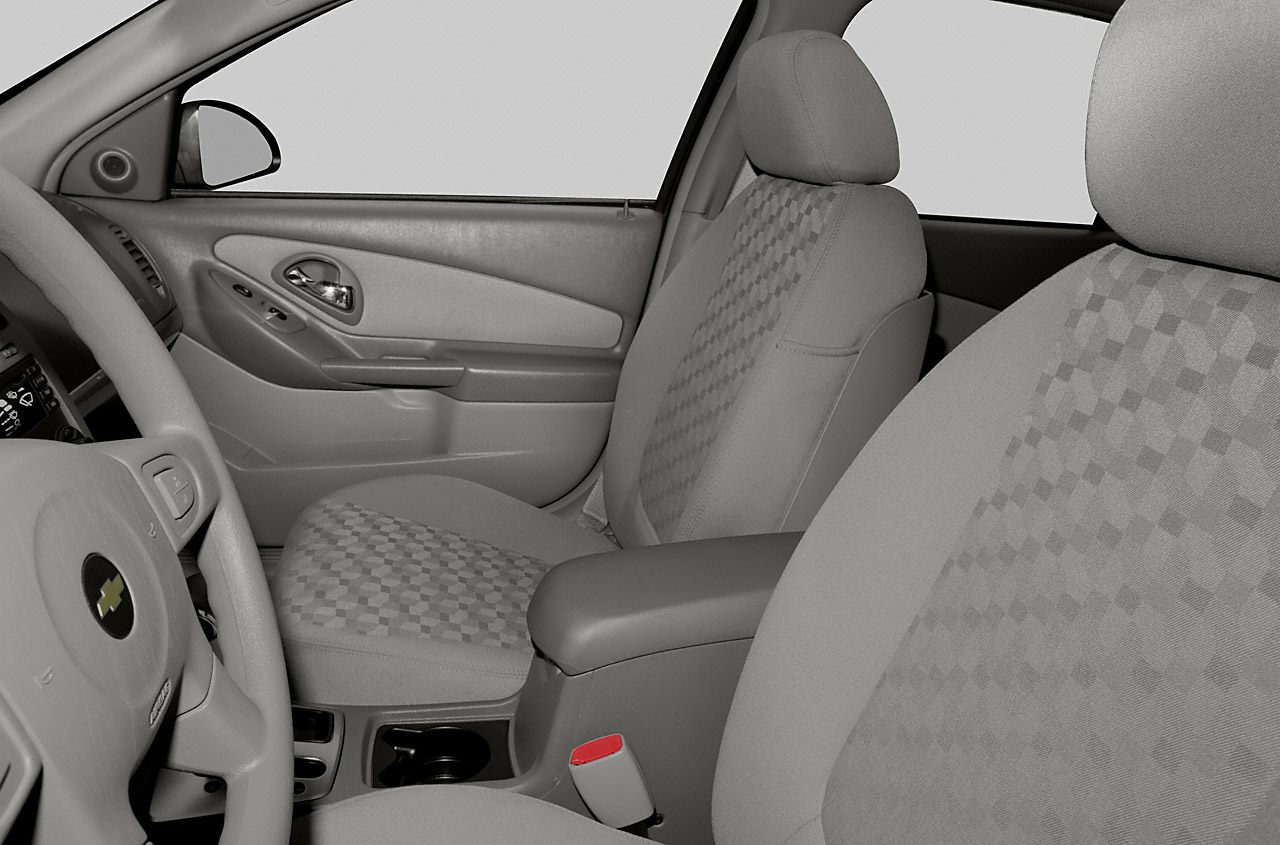 Front seats and door panel with armrest and seatbelt buckle close-up
