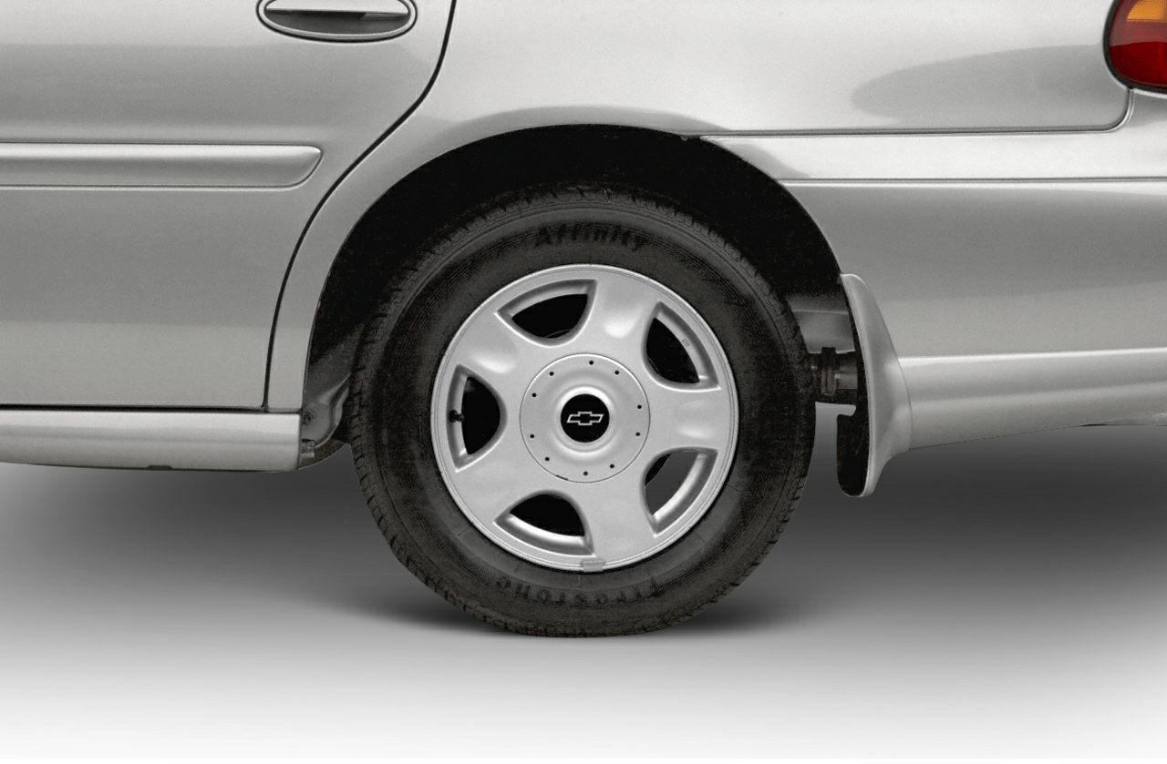 Close-up of rear wheel and tire with emblem on sedan