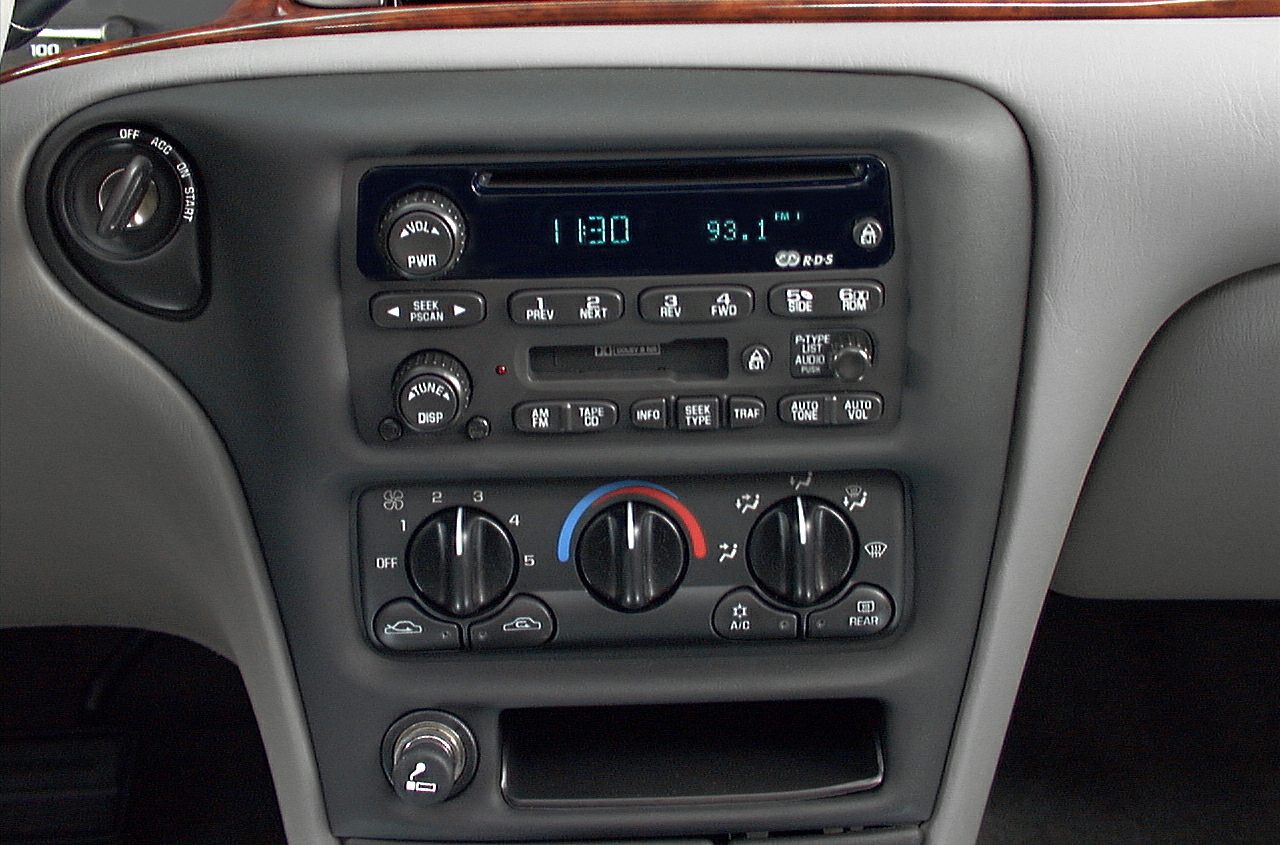 Analog radio and climate control panel with cassette player and rotary knobs