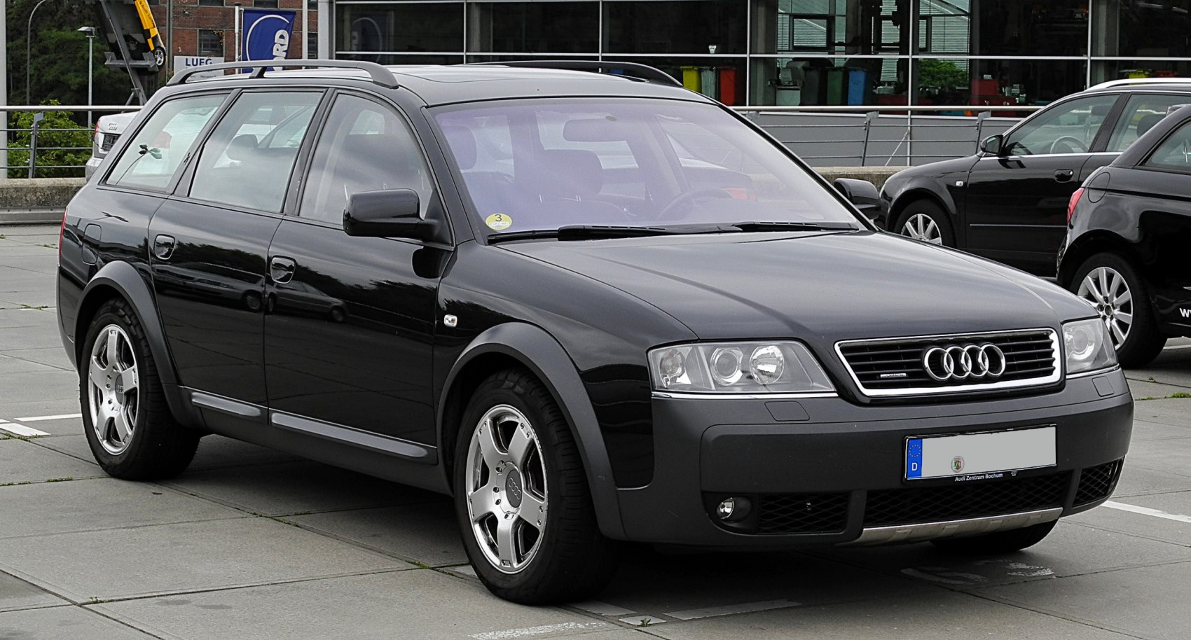 Black station wagon with rugged bumpers, roof rails, and all-terrain tires