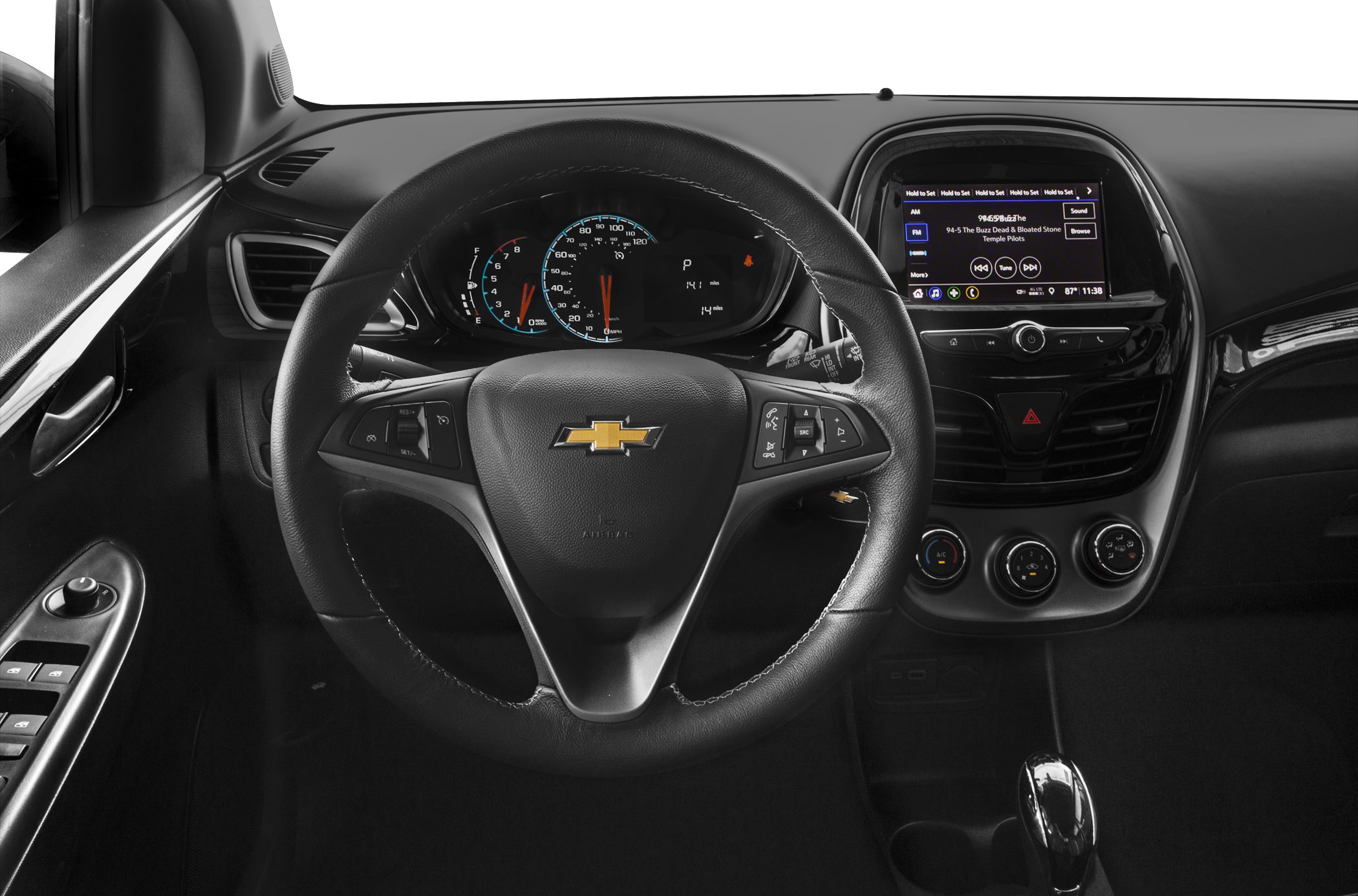 Steering wheel with control buttons and dashboard with infotainment system.