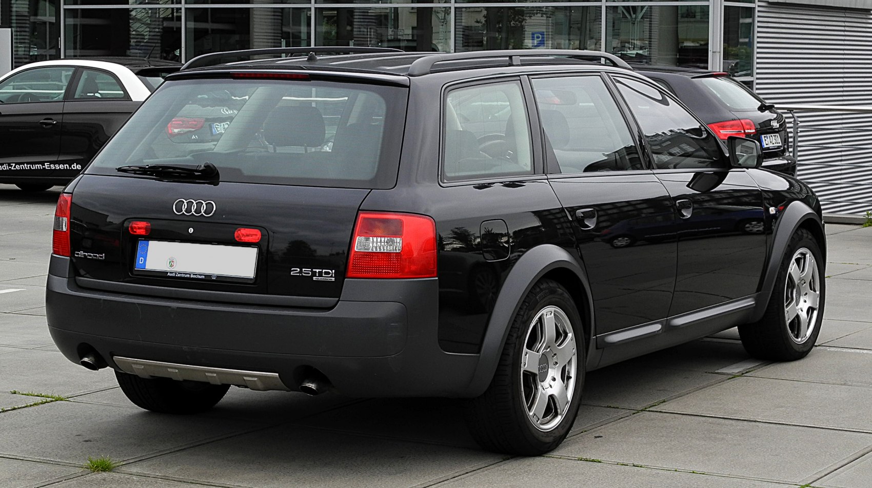 Rear side view of a wagon with distinctive tail lights and roof rails