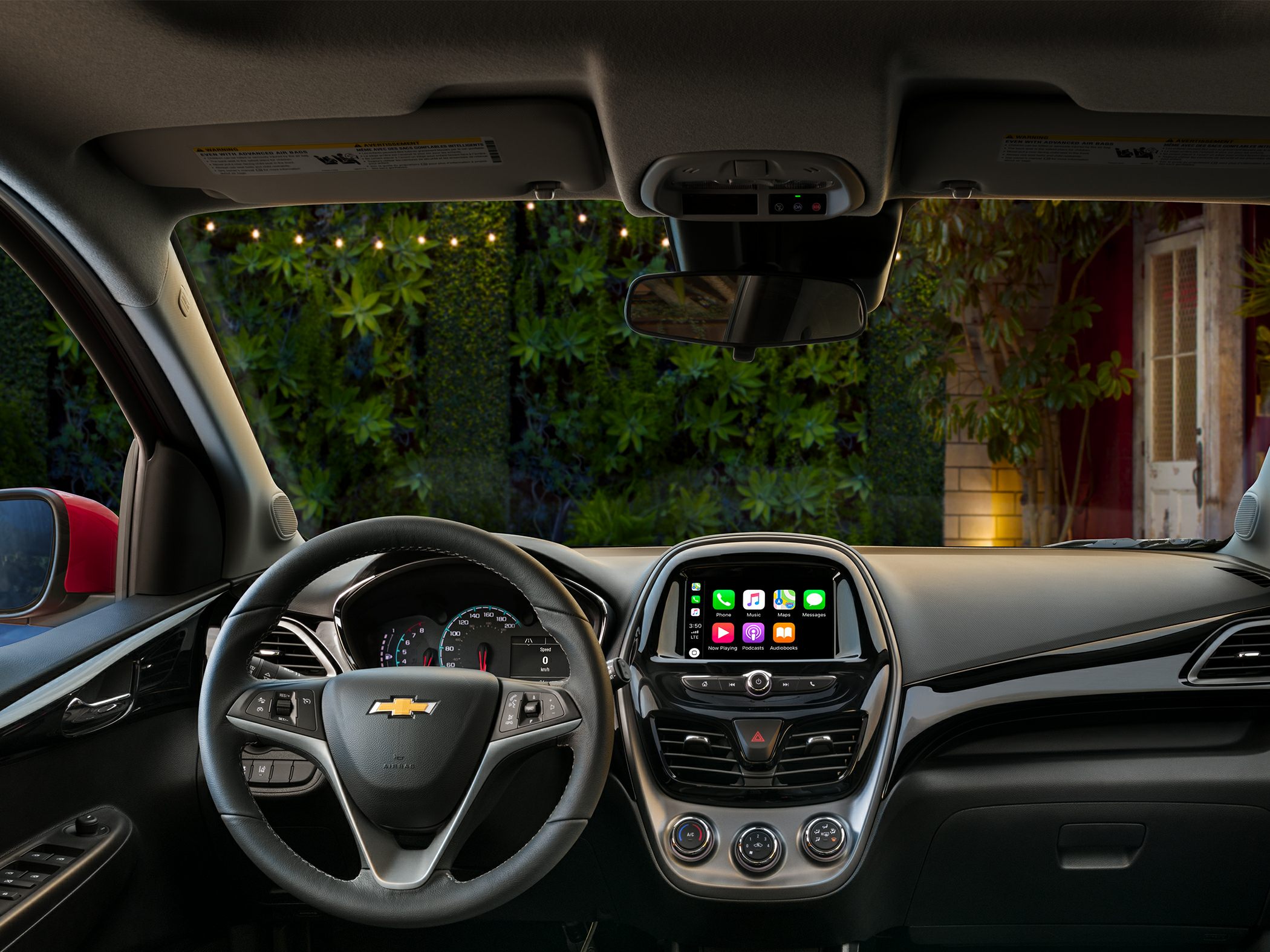 Dashboard, steering wheel with controls, infotainment system, AC dials