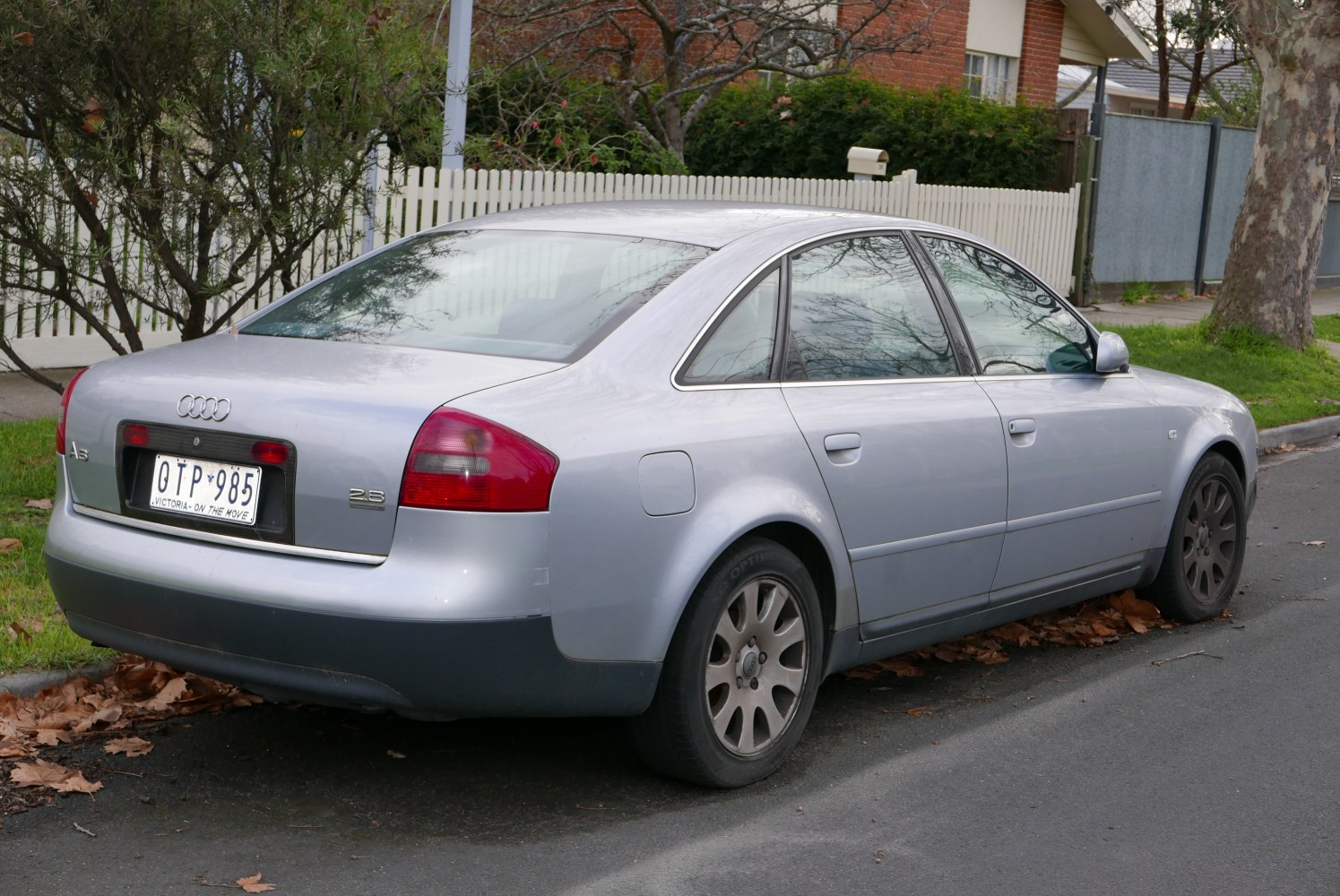 Silver sedan rear and side view with alloy wheels and taillights