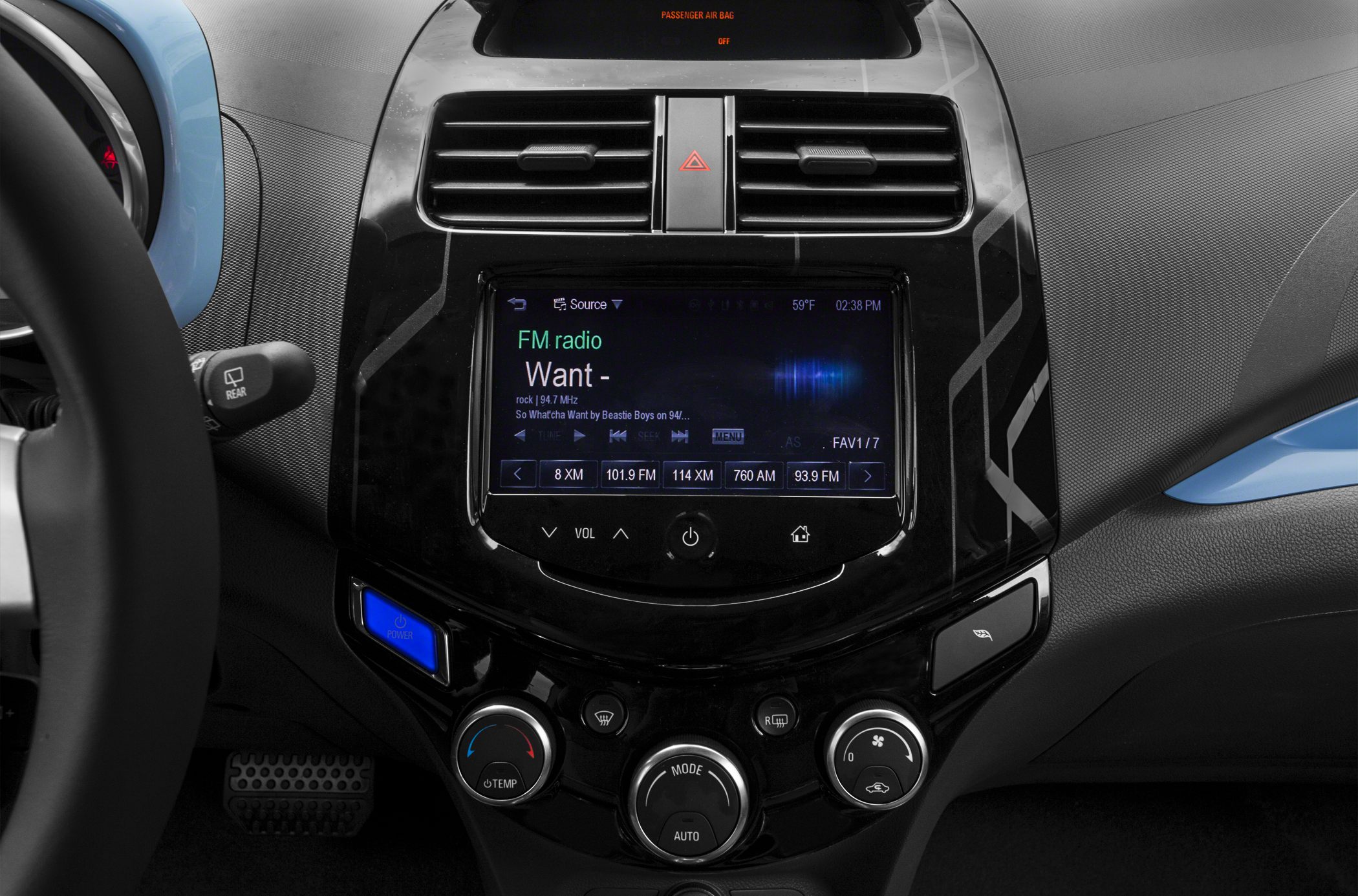 Digital infotainment touchscreen with climate control panel and dashboard air vents.