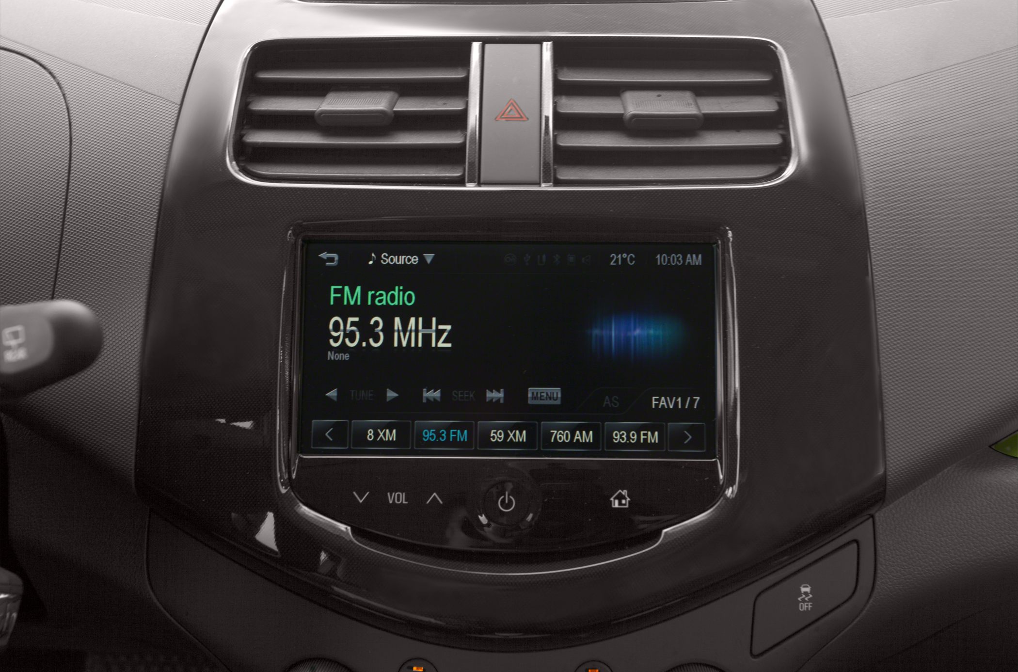 FM radio display and dual air vents in car dashboard