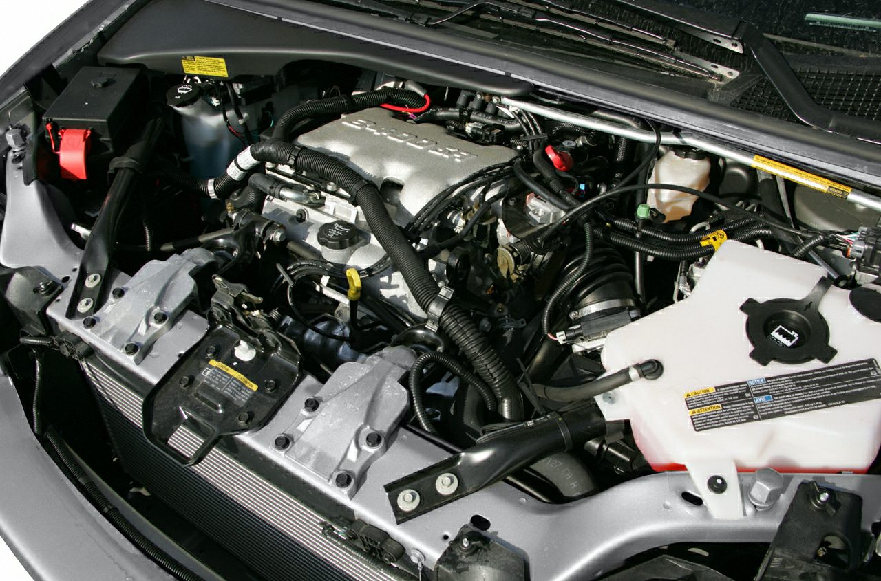 Detailed close-up of engine bay with hoses and fluid reservoirs