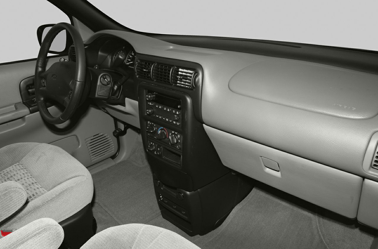 Dashboard and center console with steering wheel, vents, controls, and glove compartment