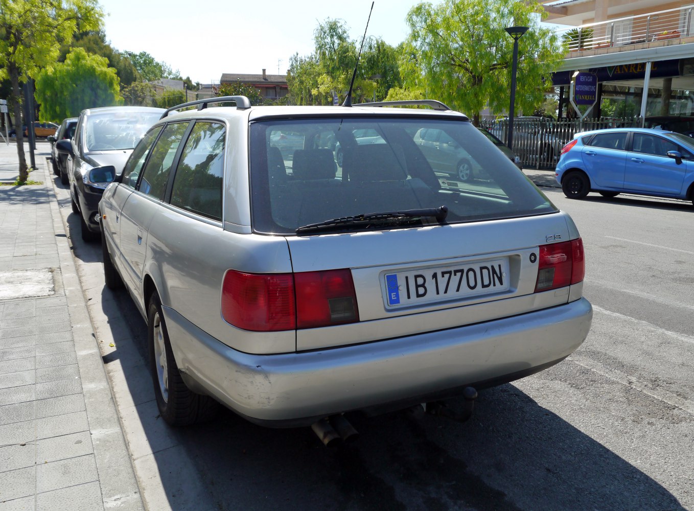 Rear view of a classic station wagon with prominent tail lights and roof rails.