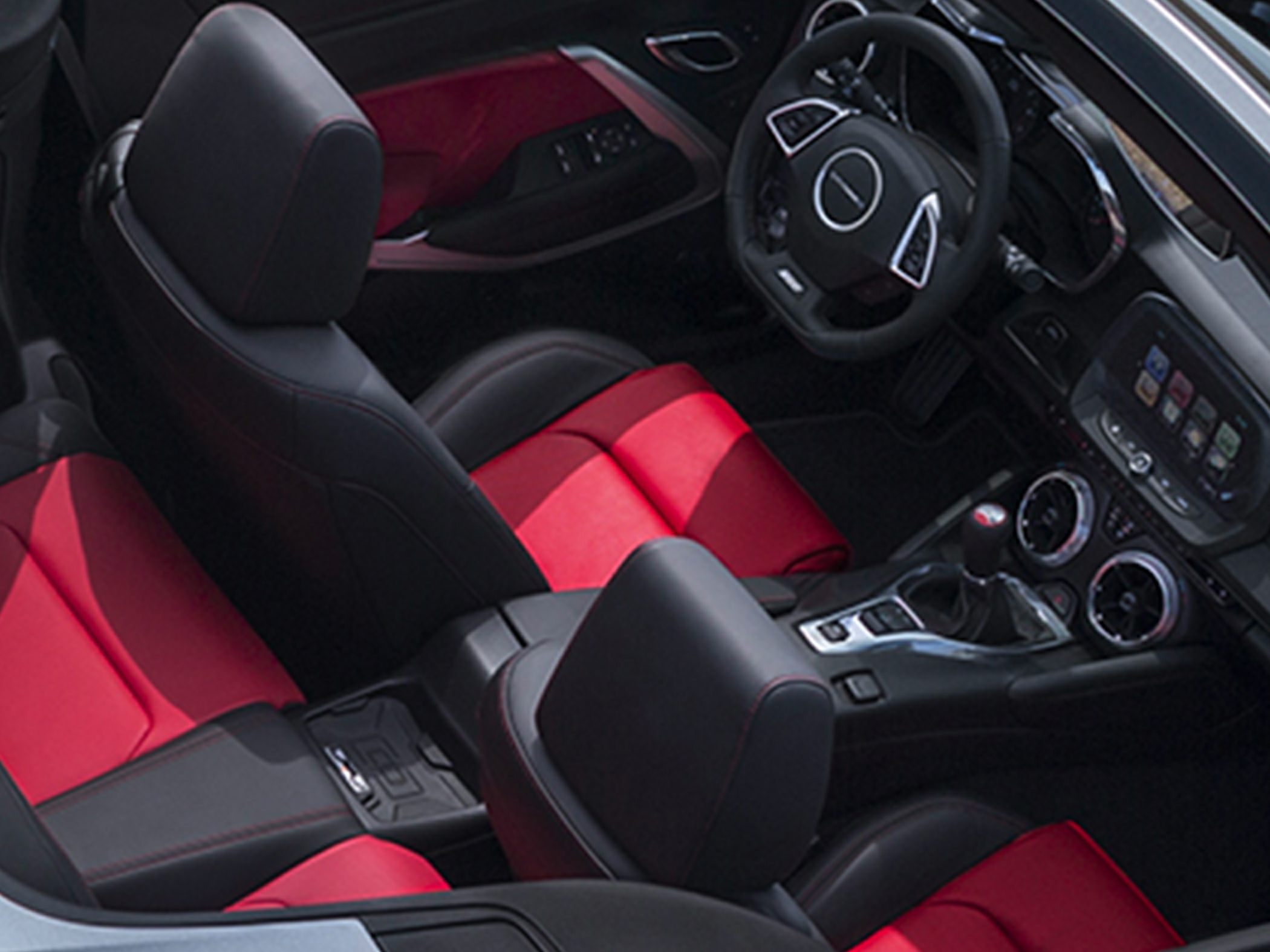 Sporty red and black seats with modern dashboard and steering wheel controls.