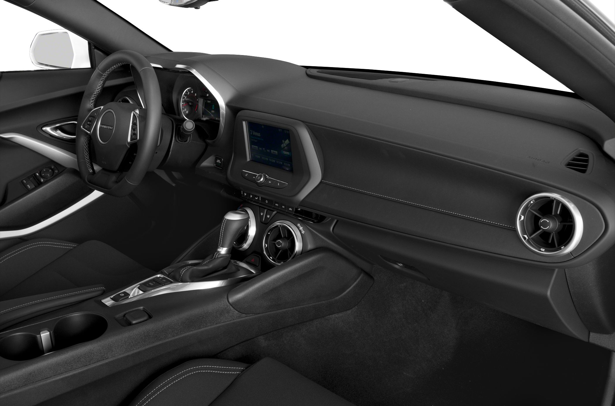 Car interior with steering wheel, dashboard, infotainment screen, and gear shift