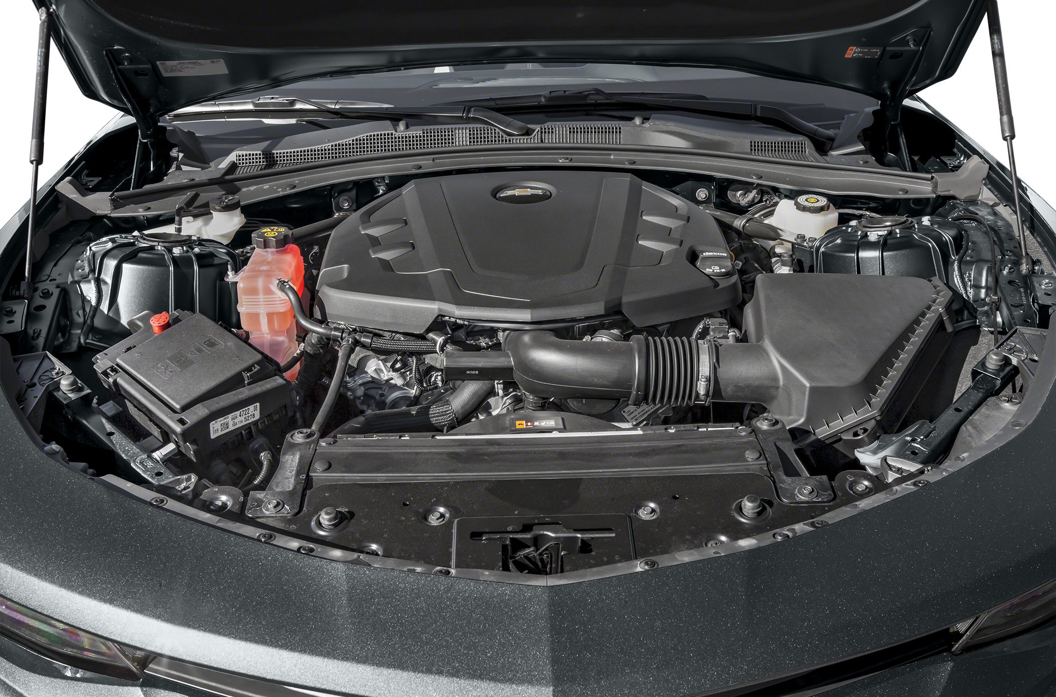 Engine bay with engine cover and air intake system in a modern muscle car.