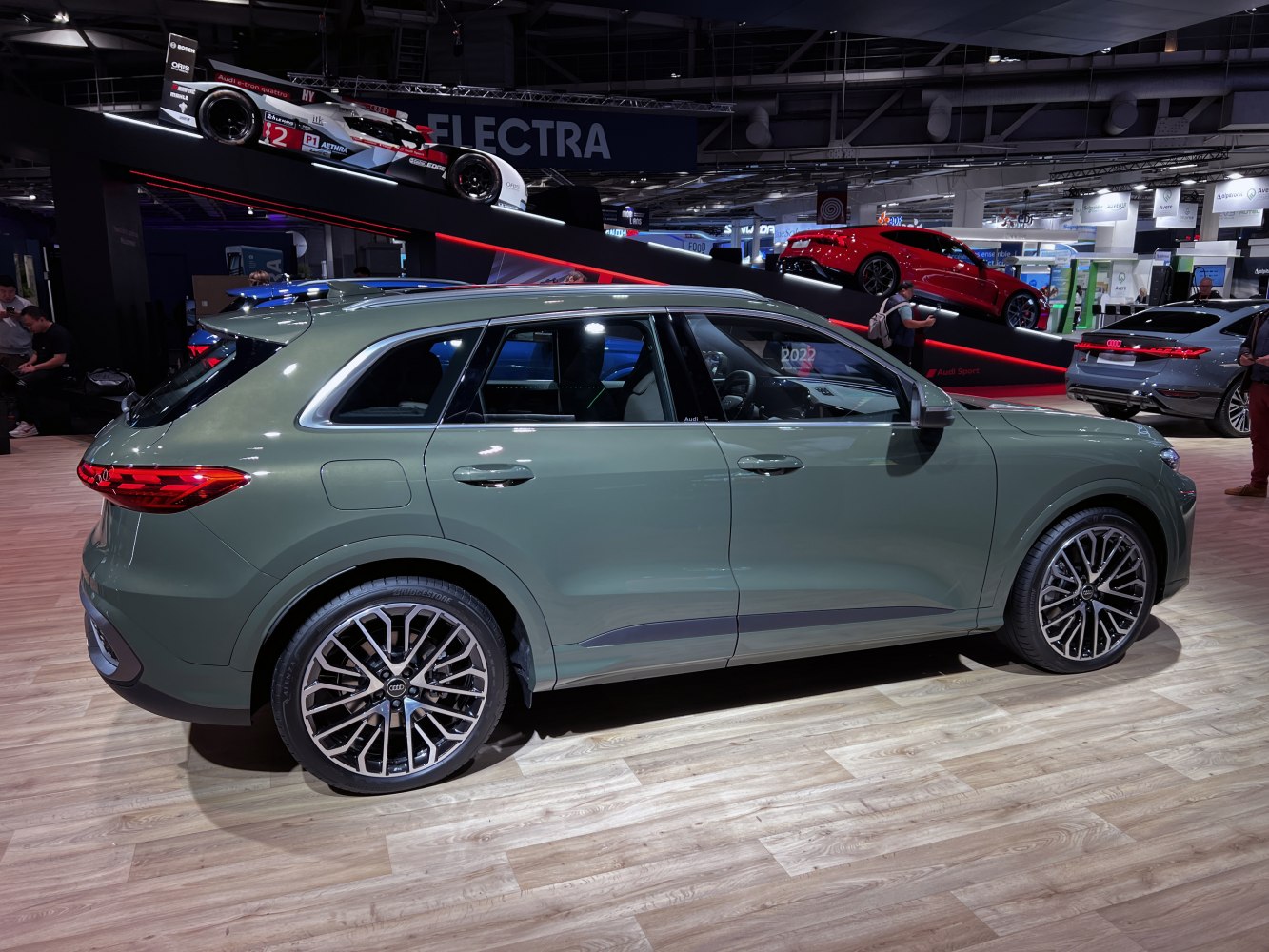 Side profile showing sleek design and large alloy wheels.