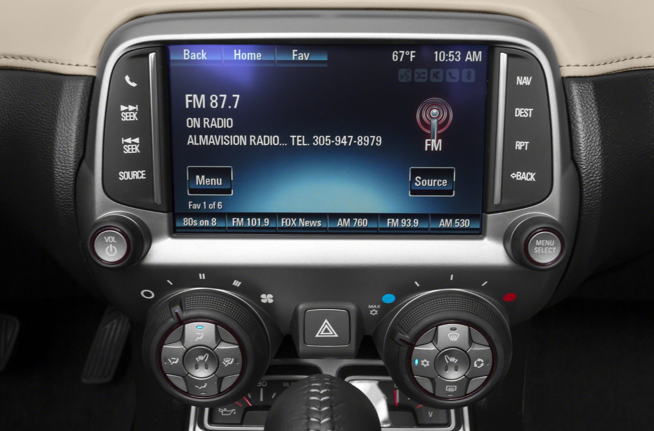 Infotainment screen with FM radio display and rotary climate control knobs