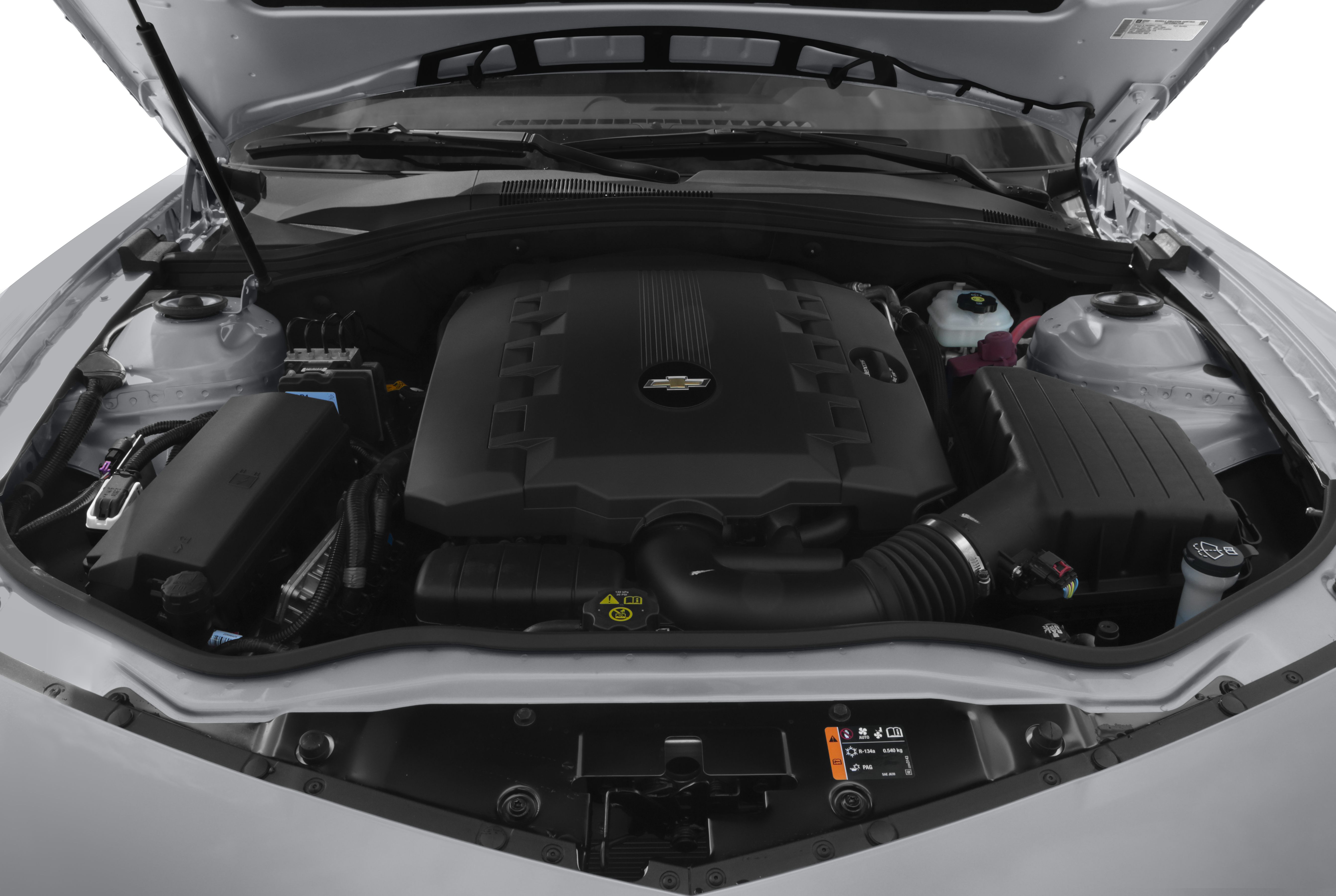 Close-up of engine bay with large engine cover and surrounding components