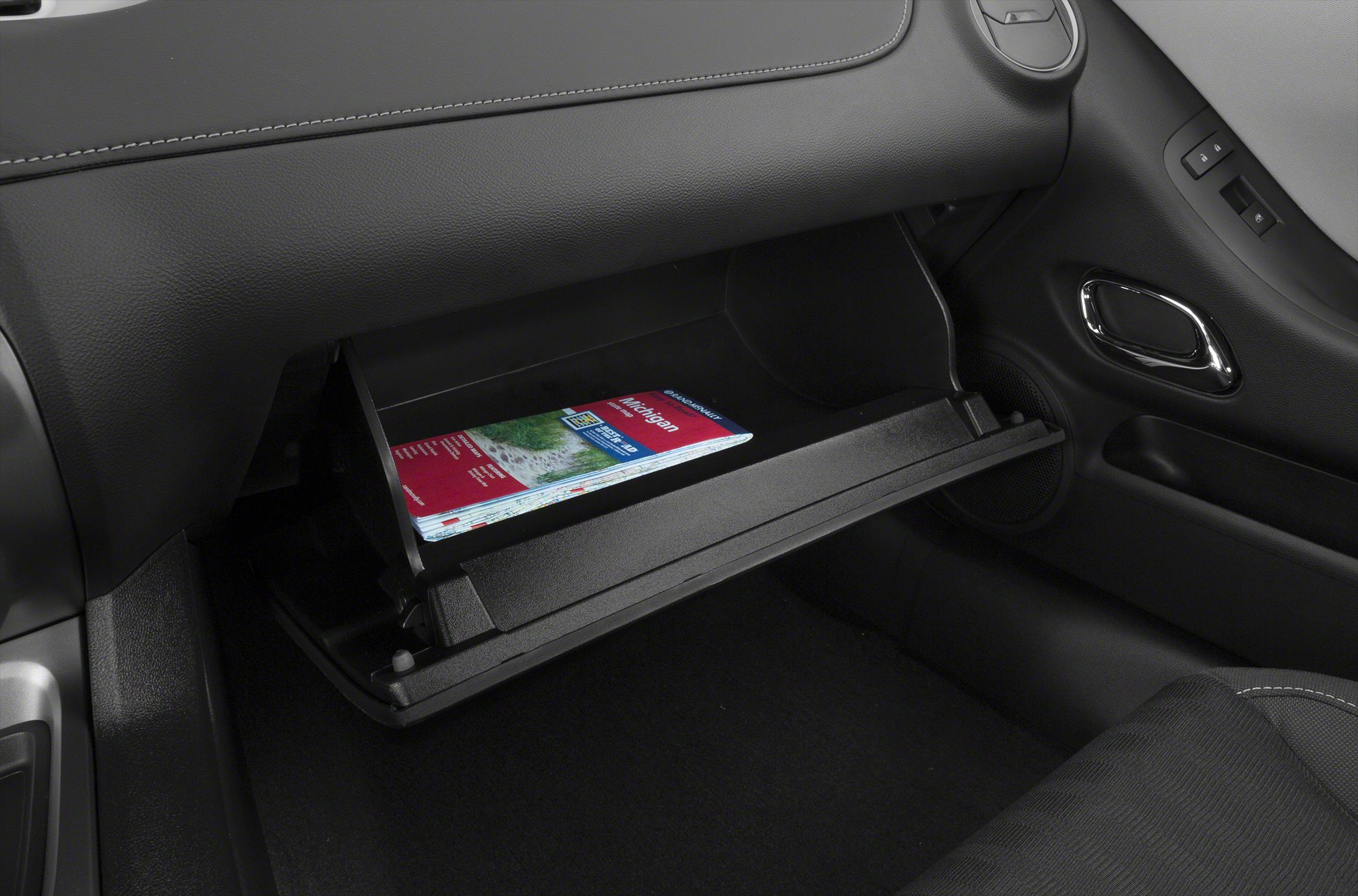 Open glove compartment with a map inside in a car interior