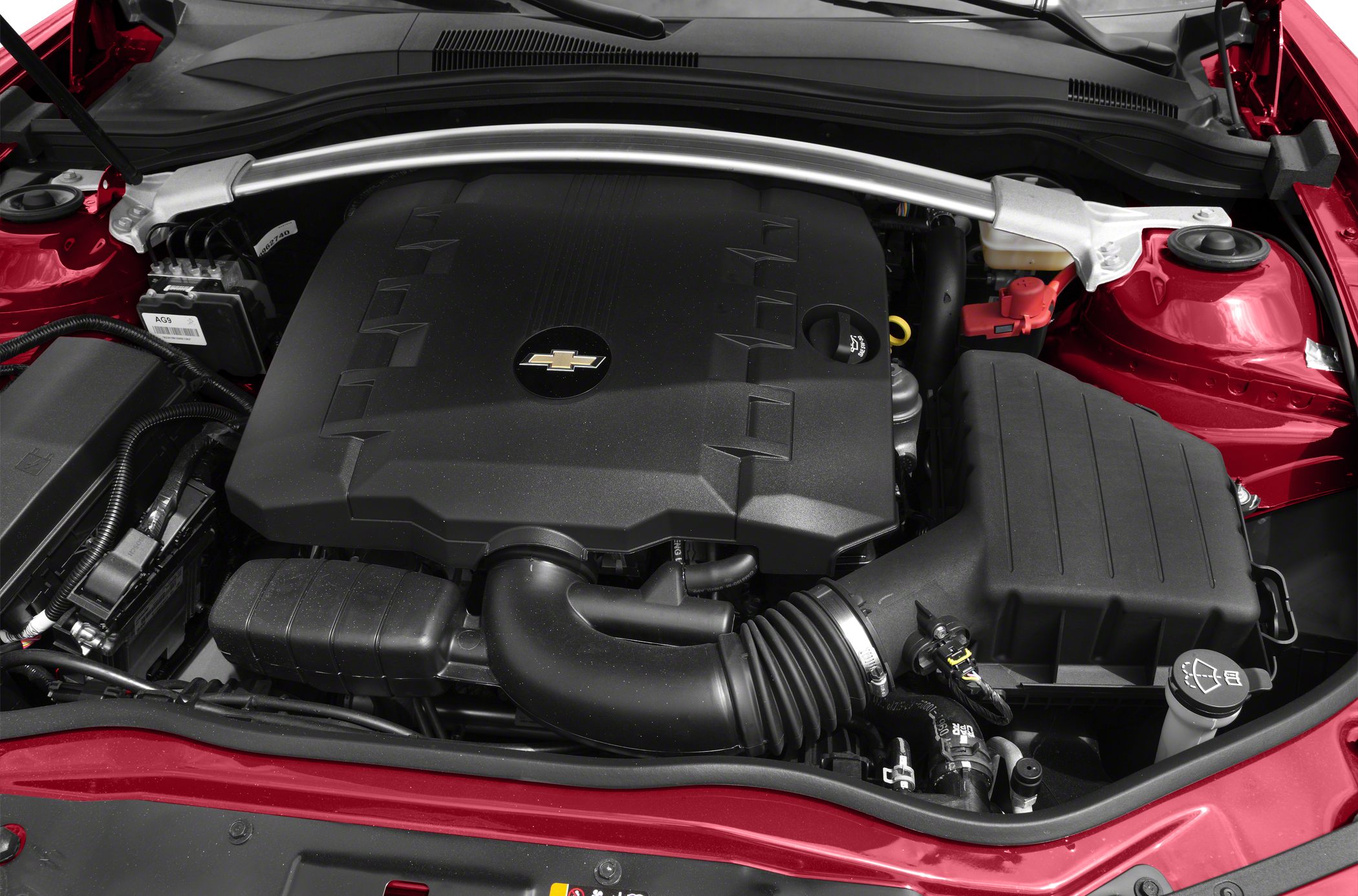 Close-up of engine bay with Chevrolet engine cover and intake system.