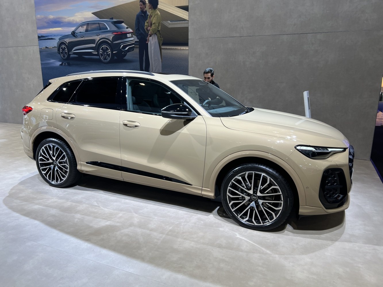 Beige SUV with sleek LED headlights and multi-spoke alloy wheels.