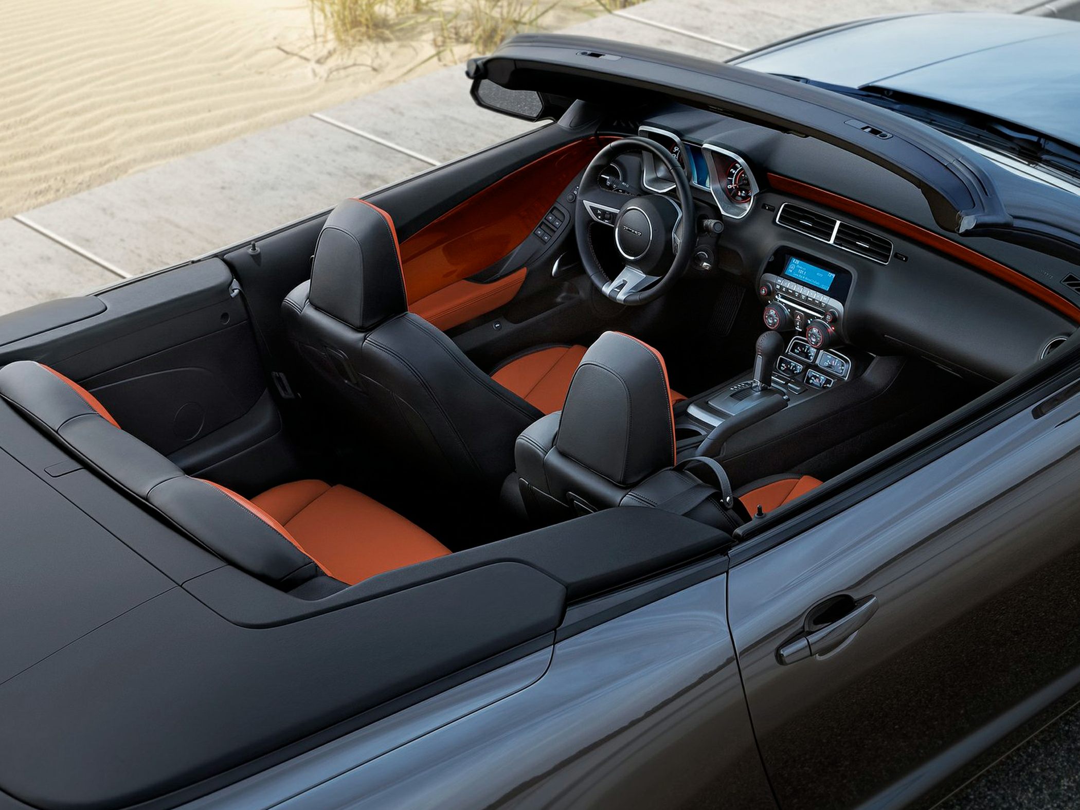 Convertible interior with black and orange seats and modern dashboard