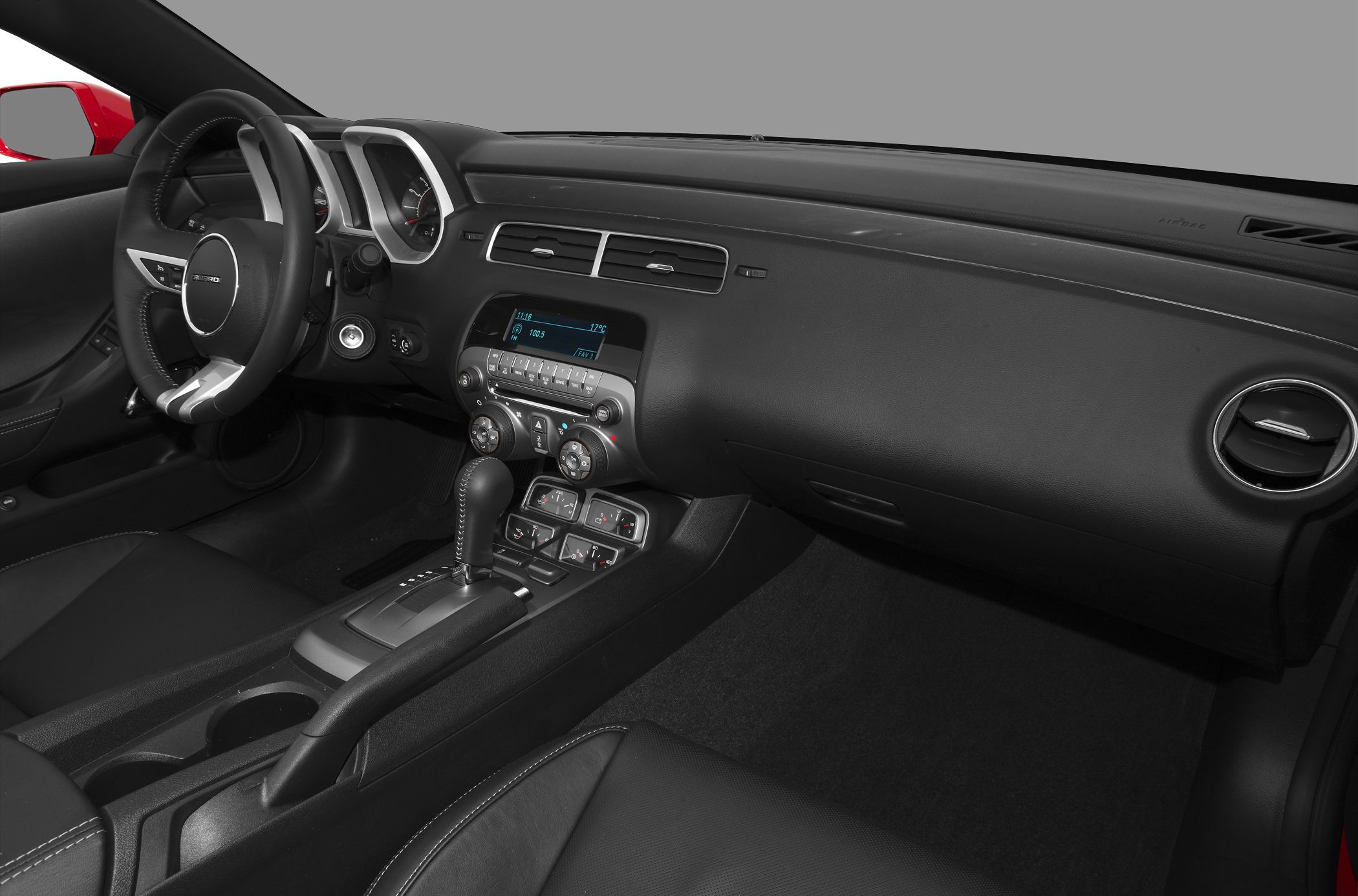 Interior dashboard, steering wheel, and center console with gear shift