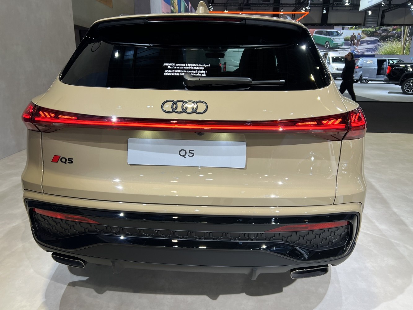 Rear view with continuous LED tail light strip and dual exhaust outlets