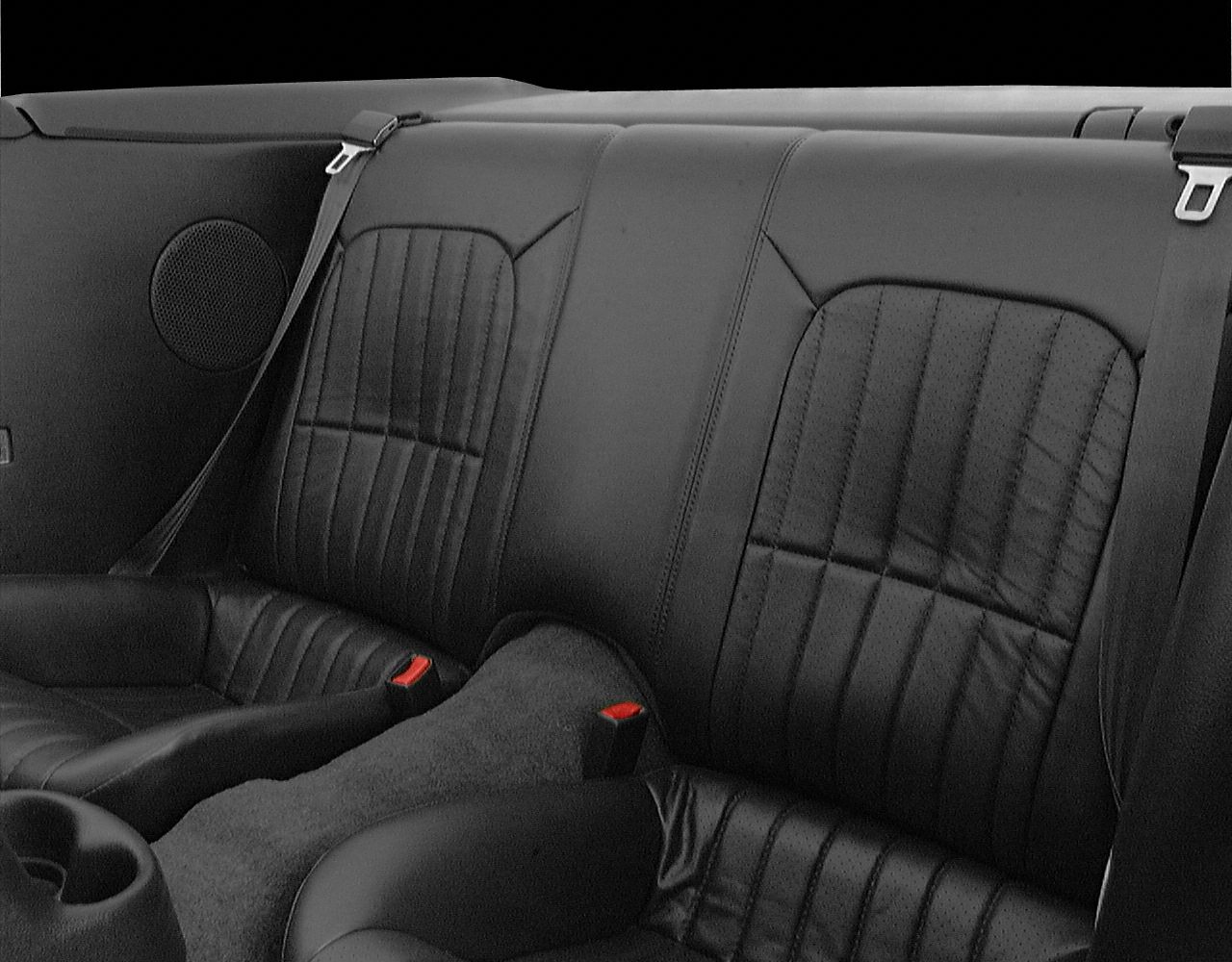 Leather rear seats with seat belts and round speaker in convertible interior