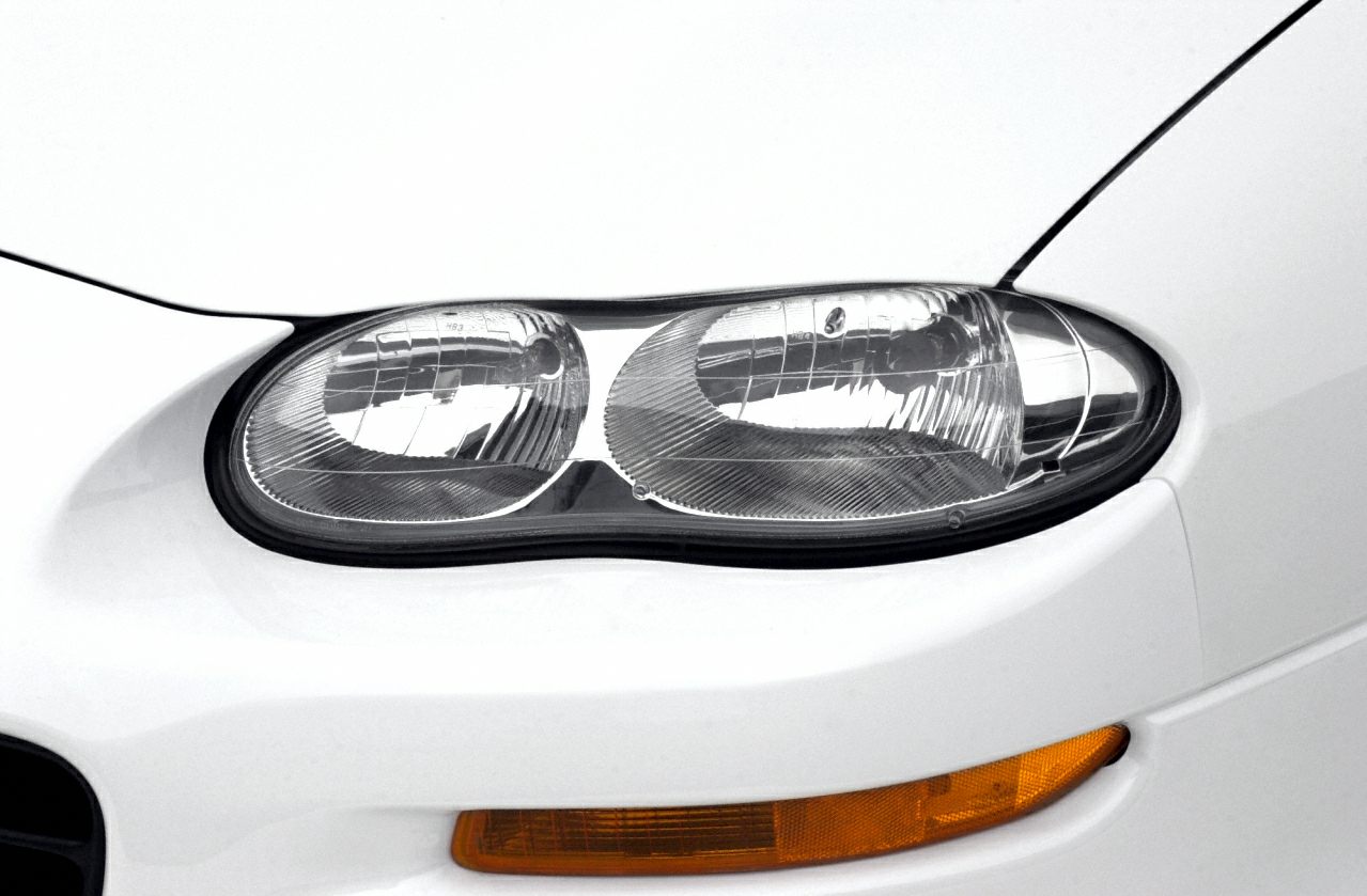 Dual oval headlights with orange turn signal light on white body