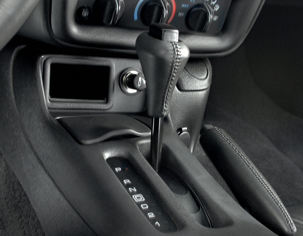 Automatic gear shifter and handbrake inside car interior