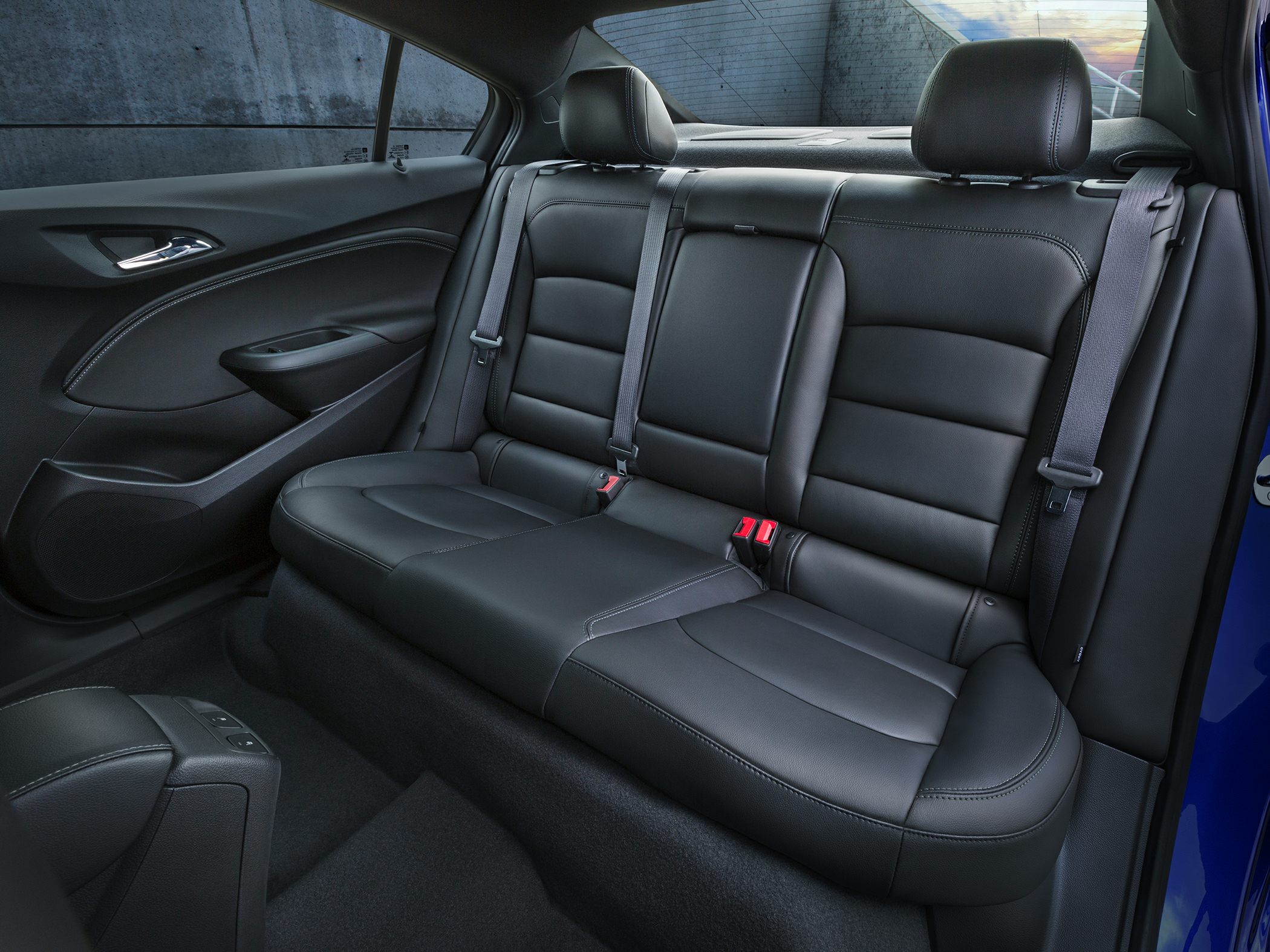 Rear leather seating with headrests and seatbelts in a sedan interior