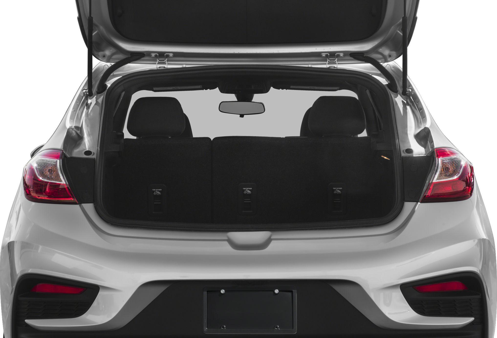 Open rear hatch with visible cargo space and folded rear seats in hatchback