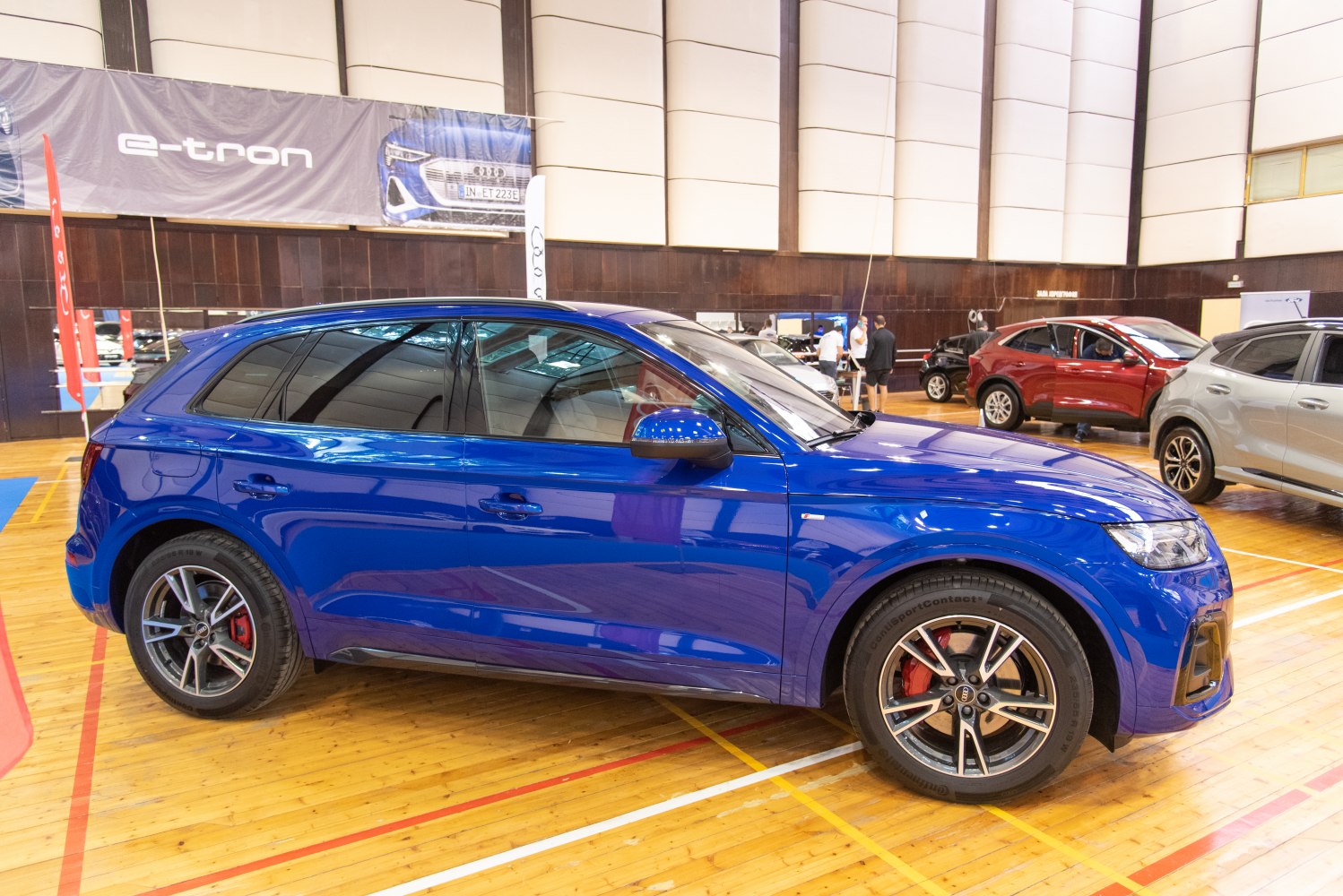 Blue SUV with tinted windows and alloy wheels, side profile view