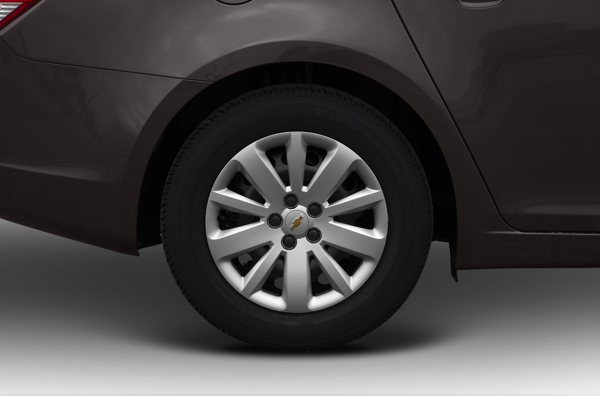 Close-up of wheel with multi-spoke alloy rim and tire on a dark vehicle body.