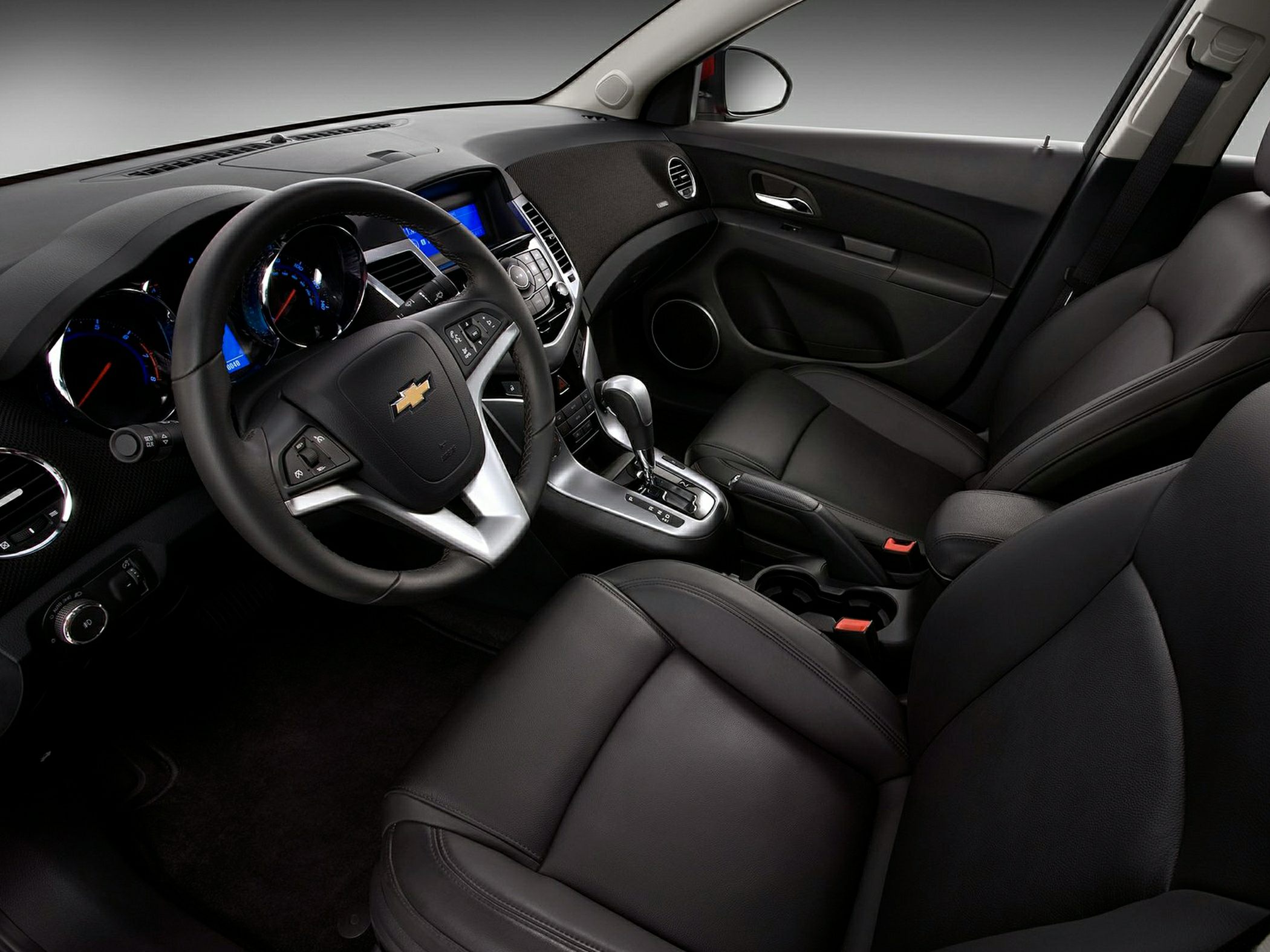 Car interior with steering wheel, dashboard, and leather seats