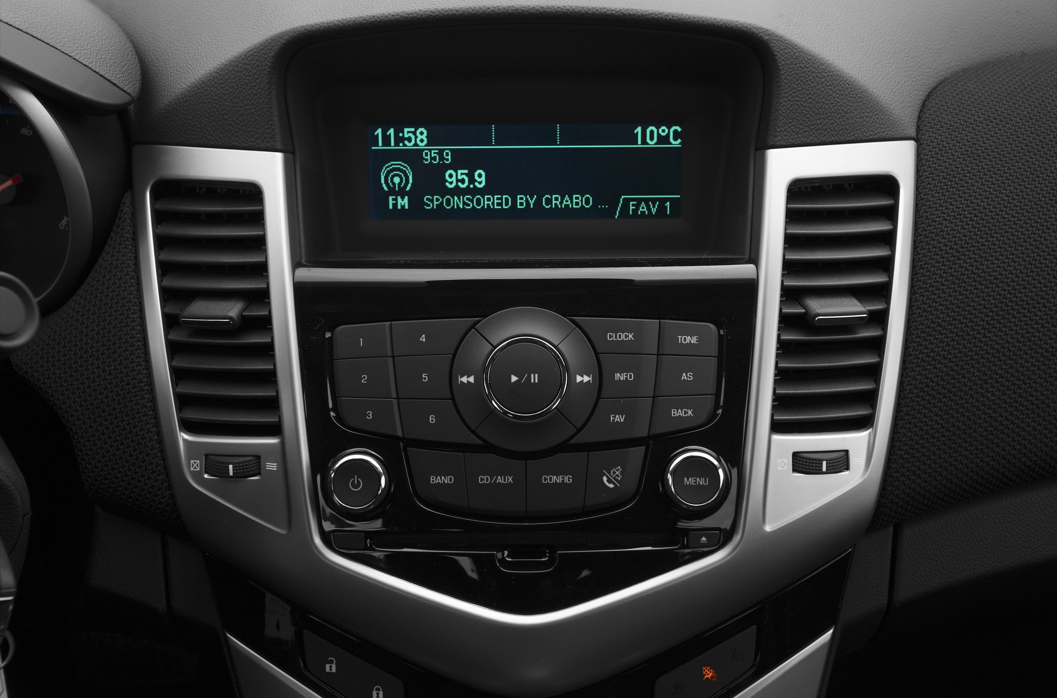 Car radio console with control buttons and digital display.