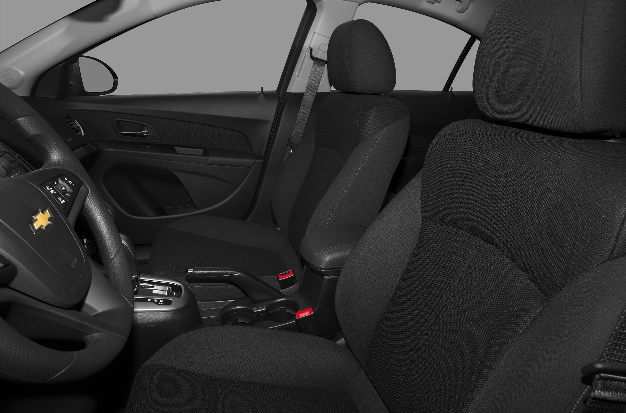 Front seats, steering wheel, and dashboard interior with fabric upholstery
