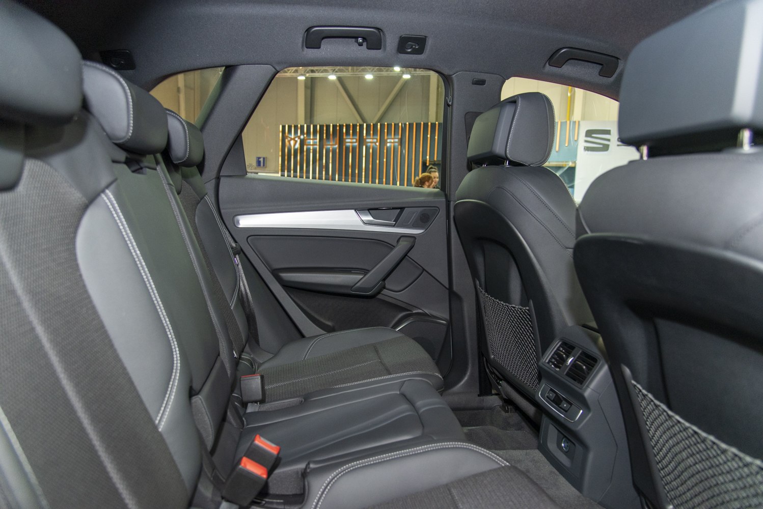 Rear seat leather upholstery and rear air vents in car interior