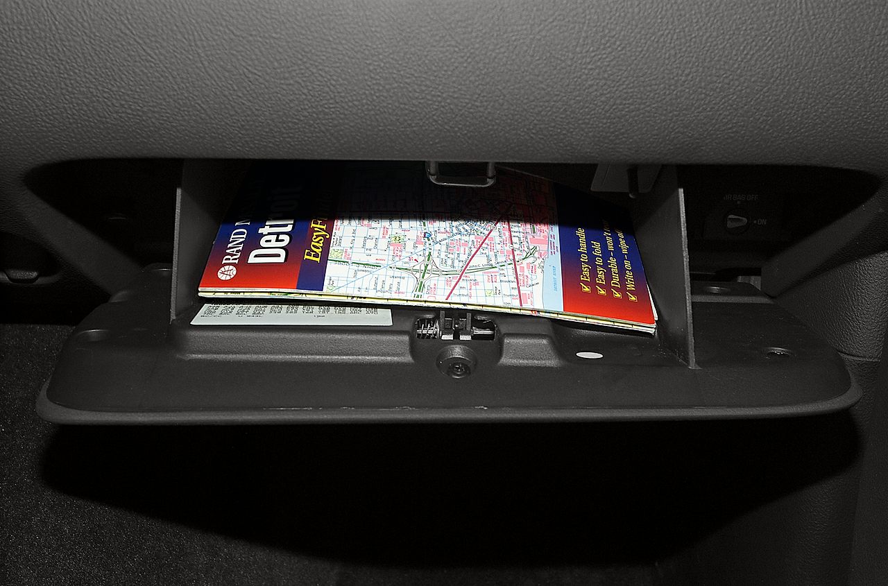 Open glove box with folded map inside