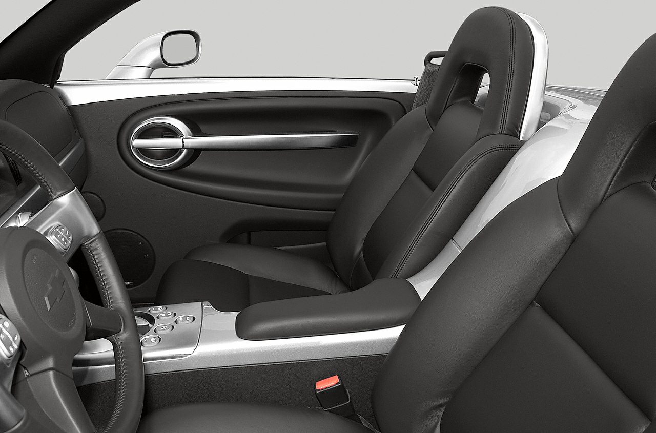 Black leather seats with chrome accents inside car