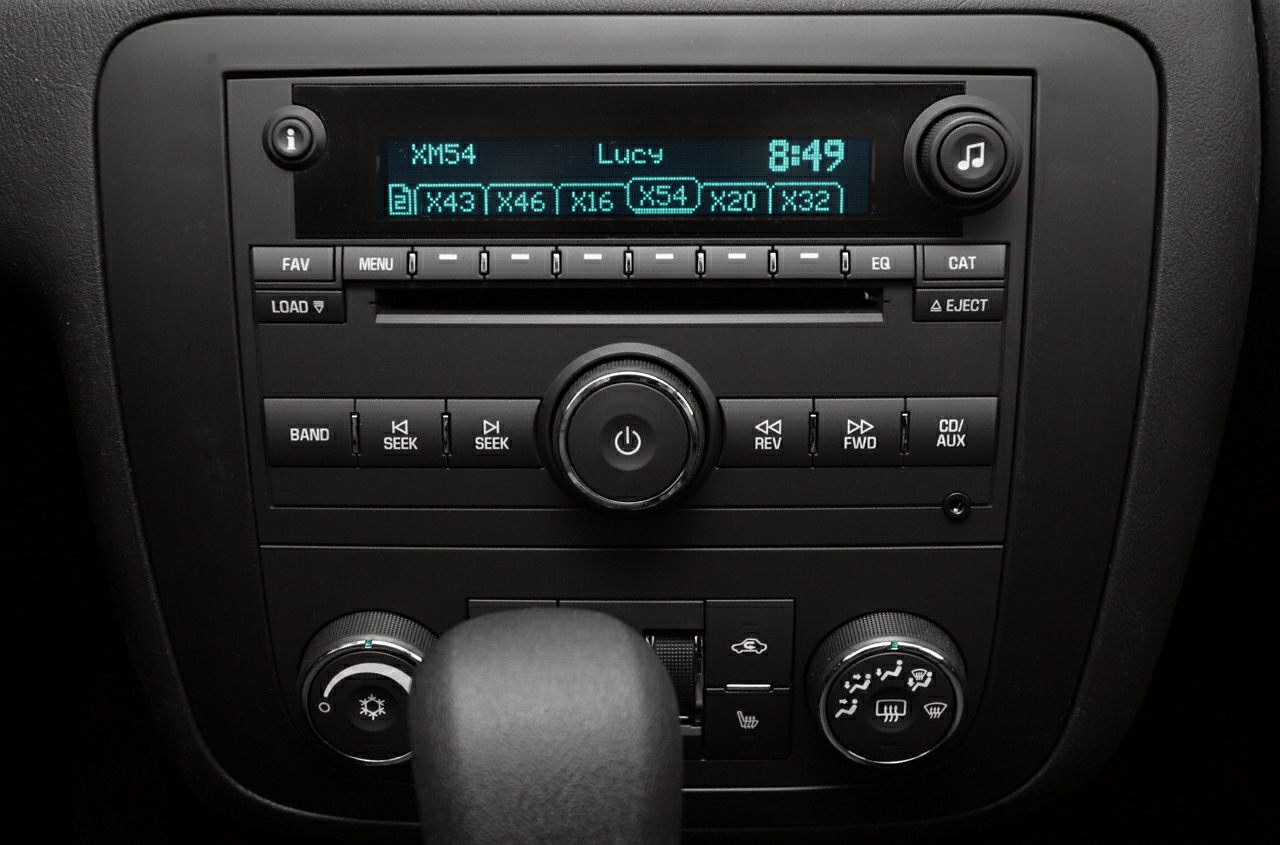 Car stereo system and climate control panel with knobs and buttons.