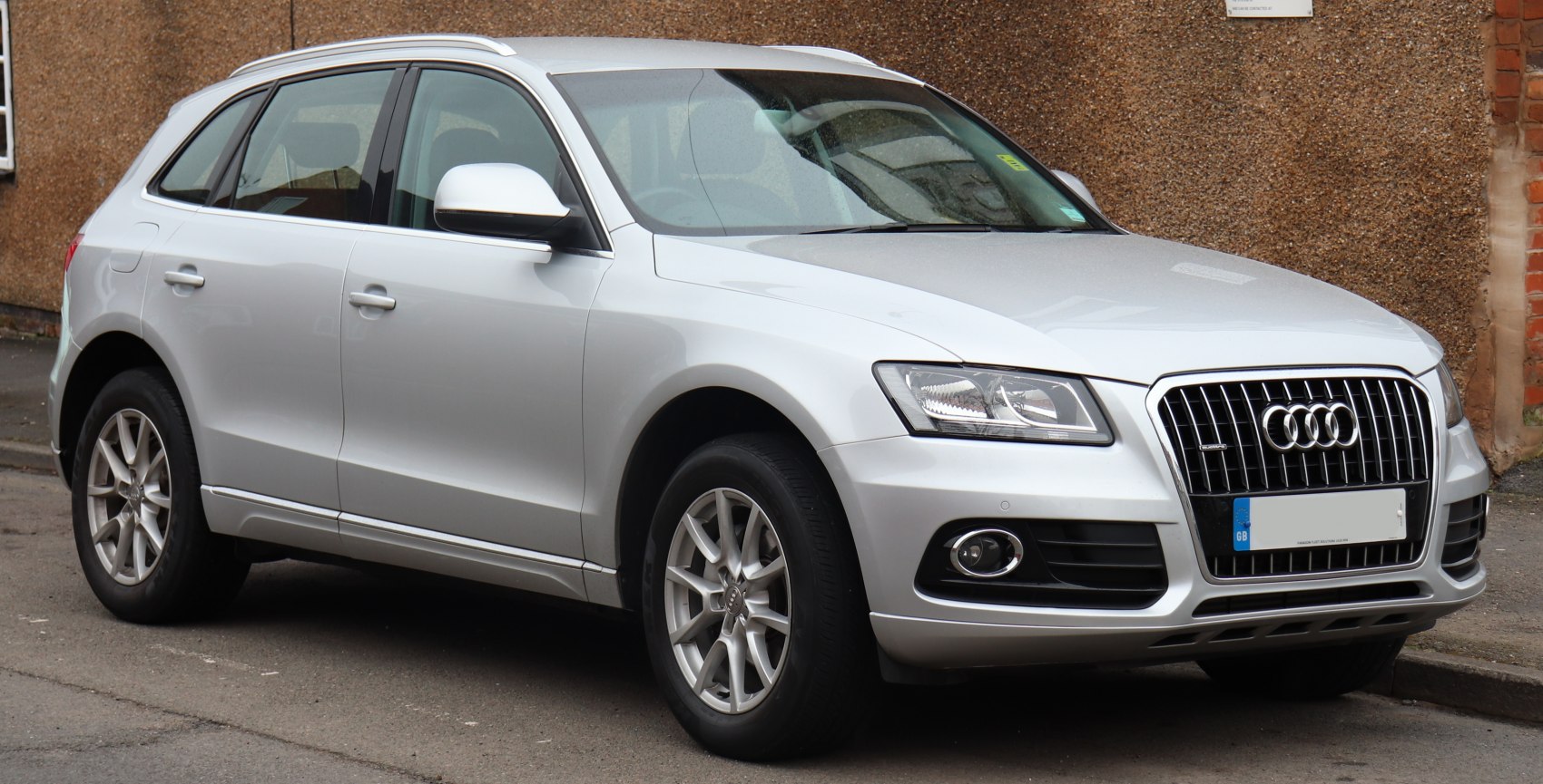 Silver SUV with distinctive grille and headlights front view